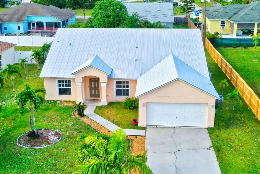This spacious single family house is located in a great neighborhood and features 4 bedrooms, 2 bathrooms, and a2-car garage and driveway for 4 more cars. The total area of the house, including the garage under the roof, is 2690sq. feet. The floor plan is split, with private master bedroom and bath (with separate shower and bathtub) on one side and 3 bedrooms on the other side. The house has separate bright dining, living, family rooms, and features a separate laundry room. It was updated with a new metal roof in 2019, a water heater in 2019, and an AC unit in2018. The property has a spacious backyard and lush landscape (including a mango tree), and is conveniently located with easy access to Turnpike and I95. There is no HOA.
