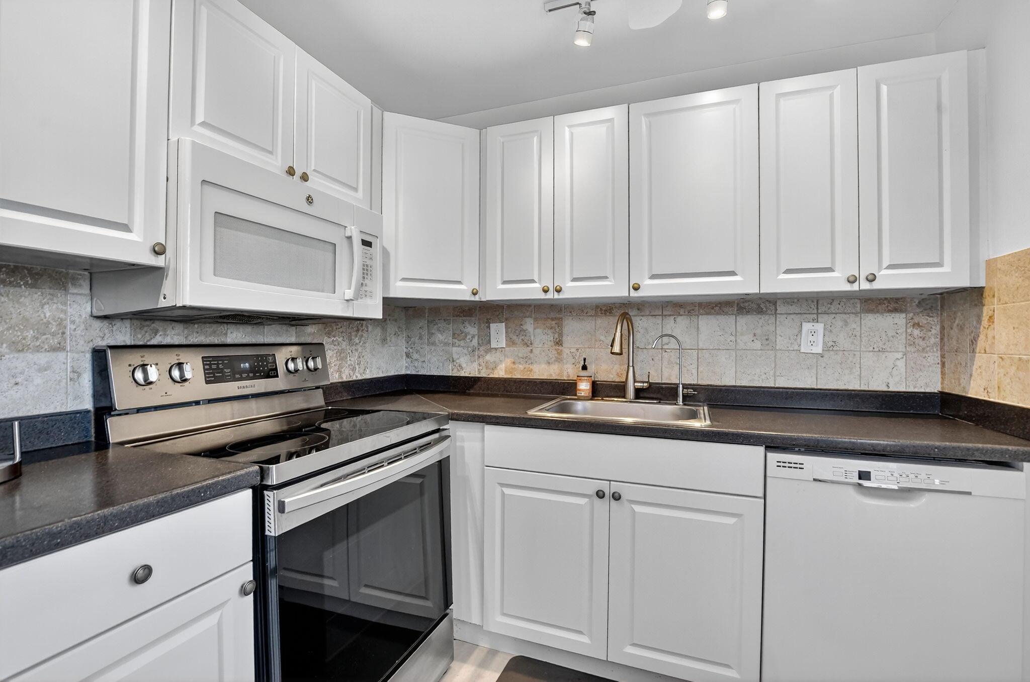 2/2 totally upgraded 1st floor on dead end street no thru traffic & located short walk to active Flanders Clubhouse. *No wait to rent unit after purchase!* Updated kitchen w stainless steel appliances, add'l cabinets, 2 showers w 1 rainfall style massage panel. Side scrn'd cov'd patio w newer washer/dryer & front garden view. Park right out front of unit. Most desirable unit in rarely offered building & location. Enjoy all amenities KP offers including 3 multi-million dollar clubhouses, 8 pools including 3 indoor pools, tennis, basketball, pickleball courts, cafes, golf courses, theater, cards, & so much more fun! Close to downtown Delray Beach & Boca Raton w malls, music, arts, culture, restaurants, entertainment, places of worship, beaches & boating. Courtesy shuttle buses everywhere!