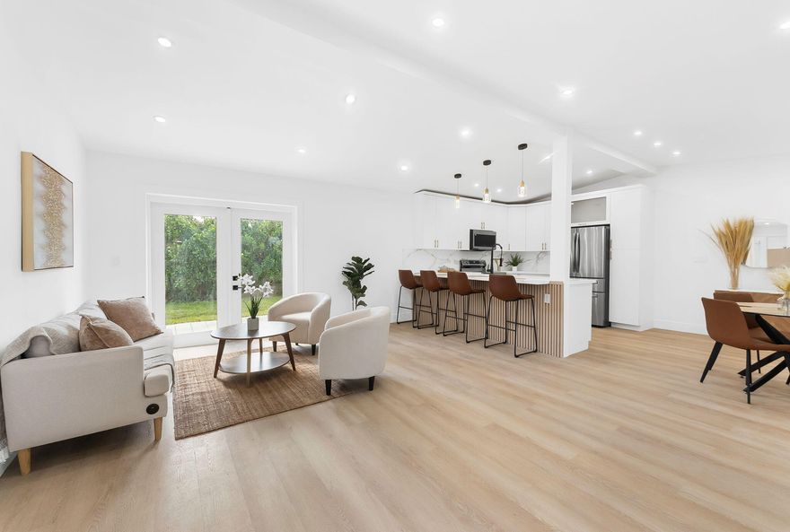 Fully renovated and move-in ready, this stunning 3BR/2BA home feels like new construction with over $120K in upgrades. Bright open floor plan with vaulted ceilings, designer kitchen with 42" cabinetry, quartz counters, oversized Calacatta quartz entertaining bar, $5,000 stainless appliance package, and coastal luxury vinyl flooring throughout. Spacious primary suite with mini-split A/C, beautifully updated baths, new central A/C, 2018 roof, new electrical panel, impact-style French doors, and full-size LG washer/dryer. Enjoy a large fenced tropical backyard, oversized patio, attached storage, fresh interior/exterior paint, plus lush tropical landscaping and a true indoor/outdoor South Florida lifestyle. Minutes to beaches, dining, shopping, and everything Fort Lauderdale offers.  Bring your buyers! This one will go quick....