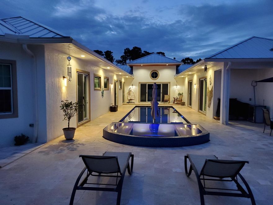 Mint condition! 3,444 sq ft custom built 2019 Builder's home with a unique floorplan, Porcelain tile floors and 14' volume Ceilings. The Kitchen features white cabinetry, Quartz countertops, Stainless Steel Appliances, oversized Island with Cooktop. Large 14k sq ft lot, Impact Windows throughout, white Vinyl Fence, 3 Car Garage, Circular Paved Driveway and a Metal Roof. Bring your cars, toys and golf cart, there is plenty of room! Elegant Travertine tile surrounds the Pool area. Pool features include a Jacuzzi, Heater and a Sun Shelf to enjoy sitting in the water under the Tiki table. No HOA!