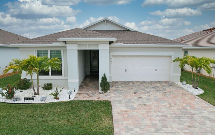 Recently reduced making this home an unbeatable buy!  Tired of standard builder upgrades? This stunning home delivers the wow factor. Built in 2024 and completely renovated. This residence boasts over $150,000 in high-end upgrades from top to bottom. Highlights include impact windows, eight-foot doors throughout, electric blinds, accent walls, and expansive 24x48 porcelain tile flooring throughout the home. The gourmet kitchen showcases quartz countertops, upgraded appliances, enhanced cabinetry, upgraded built-in pantry, under-cabinet lighting, and a sleek glass backsplash. Bathrooms have been fully renovated, including a striking porcelain tile accent wall. Enjoy outdoor living on the extended travertine tiled screened lanai, lake views, landscape lighting and gorgeous landscaping.
