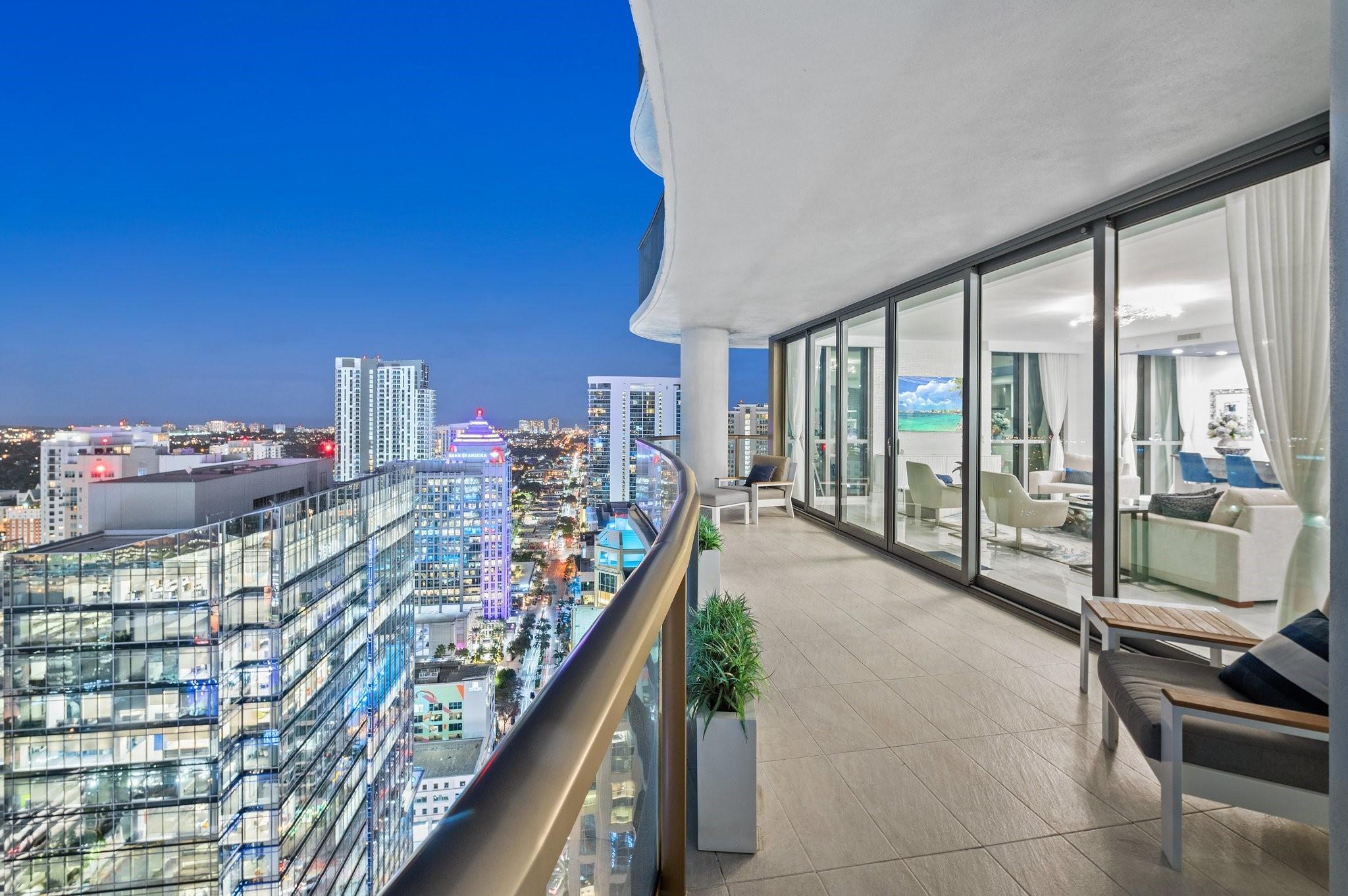Turnkey custom designed condo in Fort Lauderdale's most iconic, newer & tallest downtown address 100 Las Olas is framed by an unobstructed panoramic backdrop of the city skyline, canals, Intracoastal, New River to the ocean from every corner of your home. Enjoy best of both worlds from early sunrises to late sunsets. Magical night views. This great open layout with the best views from floor to ceiling windows, primary bedroom balcony and expansive wrap around curved terrace with tri-fold sliders is what makes this "A" model floorplan so unique & desirable. Top of the line gourmet kitchen, appliances, fixtures, furniture, custom built-in Onyx lit bar and more. This residence is an urban oasis of luxury. Smart technology. Resort style living & amenities. Restaurants, shops, theatre, ocean.