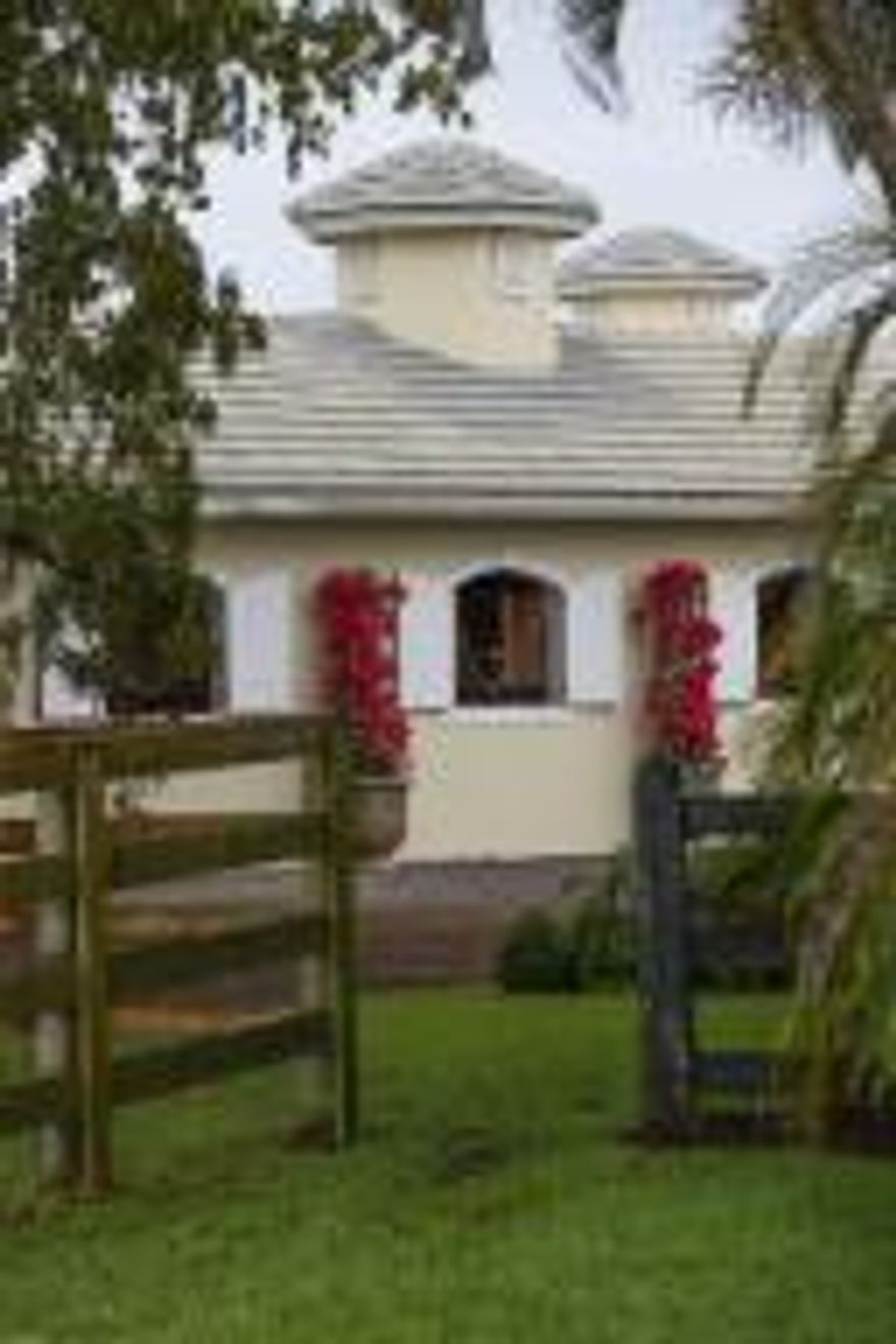 Tranquil, breezy and private, this 16 stall barn with extra options and 5 bedroom house sits on 3.67 acres in prime equestrian community in Wellington. It offers a courtyard style barn, fantastic sand arena and 7 generous paddocks. Each stall has electricity, water, fan and fly treatment. The barn is complete with grooms quarters, tack & feed room and wash & grooming stalls. The house & barn is fed with a reverse osmosis water system and there is an irrigation system throughout the property. The home is spacious with a split floor plan and vaulted ceilings. Mature shade trees surround the property, which includes a large outdoor patio with heated pool & spa. This lovely home and barn provide easy access to the Winter Equestrian Festival, which is just a short trail ride away! RX-10217417 Please  see that the property across the street is for sale as-well  You could make extra Paddock space, jumping field etc etc RX- 10217417.