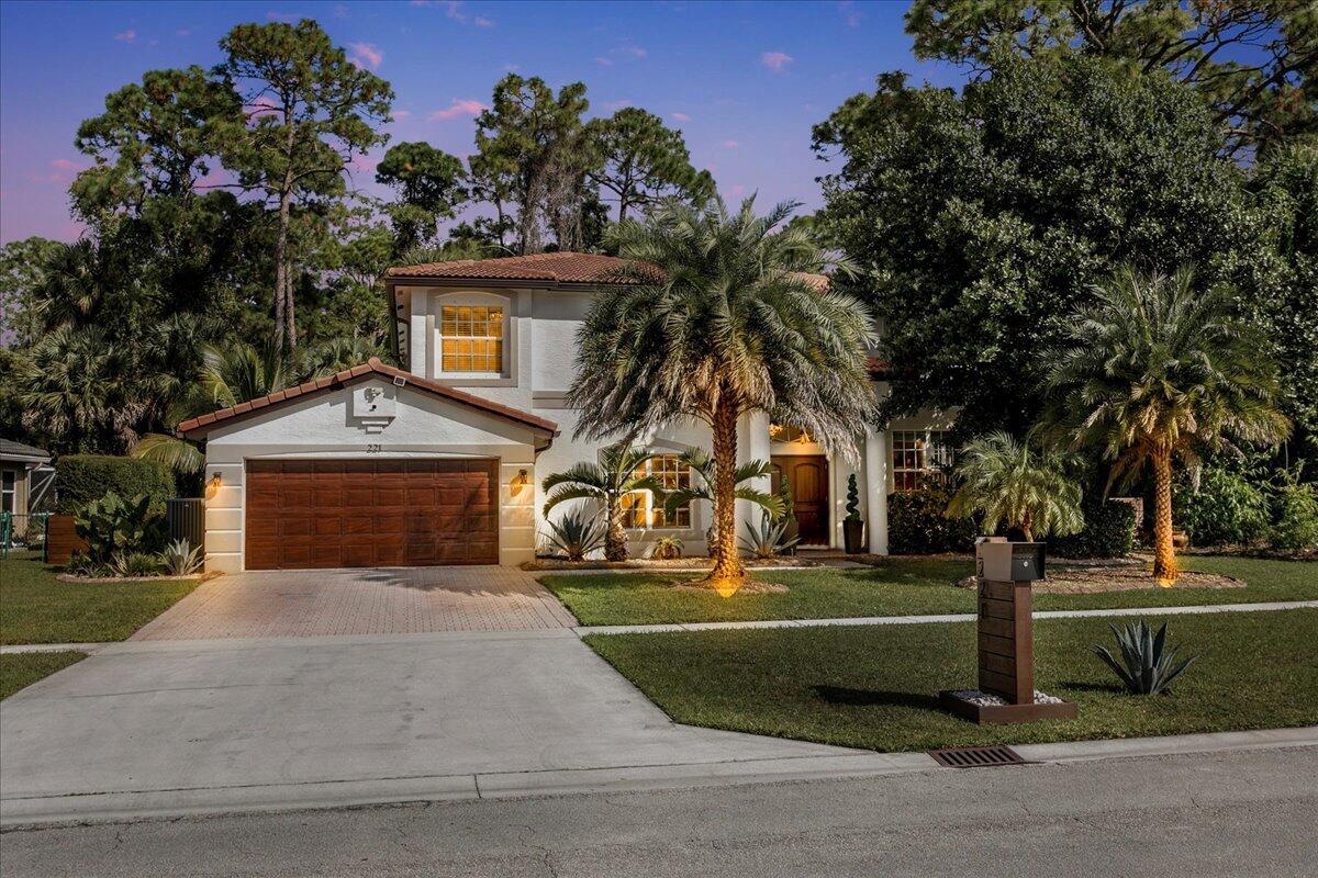 Welcome to your private sanctuary in the desirable Crestwood community, a beautifully updated residence where modern design meets effortless Florida living. Perfectly positioned on lush preserve lot with N/S exposure, this home offers a rare sense of tranquility while keeping you close to everything Royal Palm Beach has to offer. From the curb, a long driveway and manicured landscaping set the tone for what's inside. Step through the front door to find sunlit interiors, soaring ceiling, and elegant 24x24 porcelain tile flooring that flows throughout the open living spaces. The renovated kitchen is designed to impress, showcasing granite countertops, subway tile backsplash, custom soft-close wood cabinetry, LG stainless steel appliances, and double pantries for extra storage.