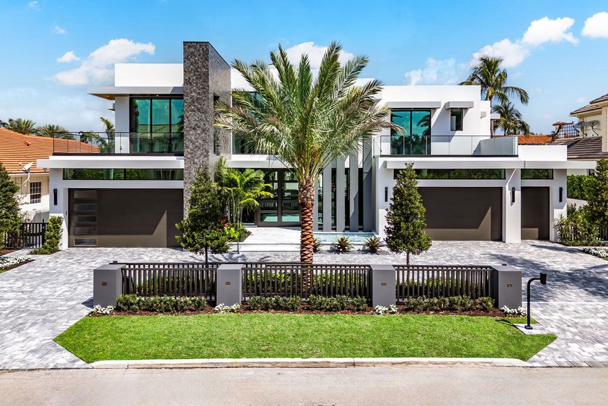 Discover a brand-new smart home crafted by Hanna Homes within the prestigious Royal Palm Yacht & Country Club! This custom estate is offered turn-key and fully furnished by Brown Interiors Design Group. With 6-bedrooms spanning over 9,500 square feet of luxurious living space, it seamlessly blends grandeur with the comfort of waterfront living. The property's centerpiece is a resort-style pool with a spa and sun shelf. The pool is complemented by an expansive covered loggia featuring a summer room and a fully equipped outdoor kitchen, perfect for entertaining or serene relaxation. Every element of this home is crafted for ultimate refinement, from the fully automated Crestron smart-home system to the state-of-the-art security features. The gourmet kitchen is a chef's dream, anchored by dual center islands, outfitted with premium appliances, and accompanied by a fully-equipped catering kitchen. The master suite is a private sanctuary, opening to an exclusive covered terrace. It boasts His & Her boutique closets, a master bath that exudes elegance, and a large sitting room with a chic two-sided fireplace. Additional spaces include a private office, a 26-foot interior garden, and a 4-car garage with a golf cart bay, ensuring you're always ready to explore the community. The buyer is responsible for documentary stamp taxes on the deed and title insurance.