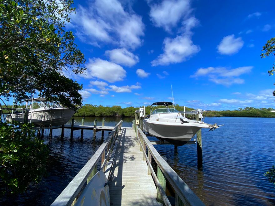 Here's your chance to live on the Wild & Scenic NW Fork of the Loxahatchee River! Modern Key West Style 4/3/3 CBS home with metal roof; 10 ft. volume ceilings; 8 ft. high doors; Accordion Shutters; Fresh exterior paint + two new Trane A/C units (2021). Very quiet private location close to the State Park,; yet only 10 minutes from I-95! Desirable Jupiter address + Martin County Taxes. Amazing views of nature & mangrove islands. Relax on the the large (private) deep-water dock which includes composite decking, water/electric; piling wrap + two 12K boat lifts. No neighbor on one side; no homes behind. Privacy w/ room for a pool. Lg screened patio w/ hot outdoor shower. Bonus room w/full bath & large balcony. Room for boats/RV. Large lot w/ higher elevation. Don't miss this unique opportunity!