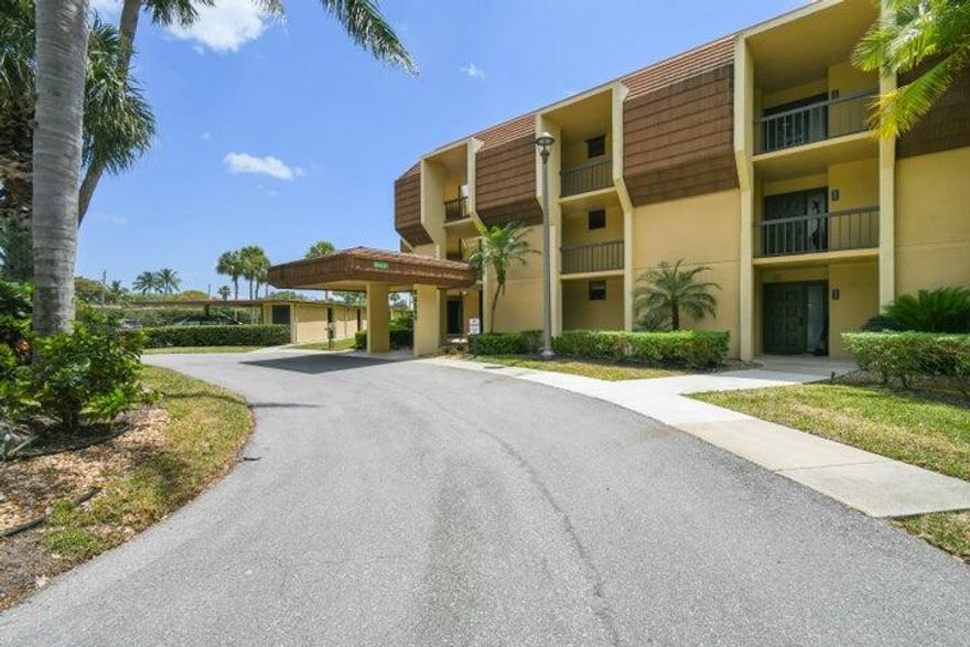 Welcome to this large 3 bedroom, 2 bath condo located in the prestigious Woodland Lakes community situated in the heart of Palm Beach Gardens. The eat-in kitchen features updated custom wood cabinetry, granite countertops, mosaic tile backsplash, white appliances, tray ceiling, tile flooring, and views of the tree-lined community. The living and dining rooms are quite spacious and light and bright with magnificent lake views to enjoy every day. The family/den is the bonus room which can be utilized as an extra bedroom, office, fitness, or a card room to enjoy. The primary bedroom is very large and includes carpeting, a huge walk-in closet, and sliding glass doors that open to a fabulous glass-enclosed porch overlooking sweeping lake views. Both vanities have been updated with granite countertops and lighting fixtures. The laundry room is inside the condo for your convenience, as well as an assigned carport and extra storage. Make this your home today.