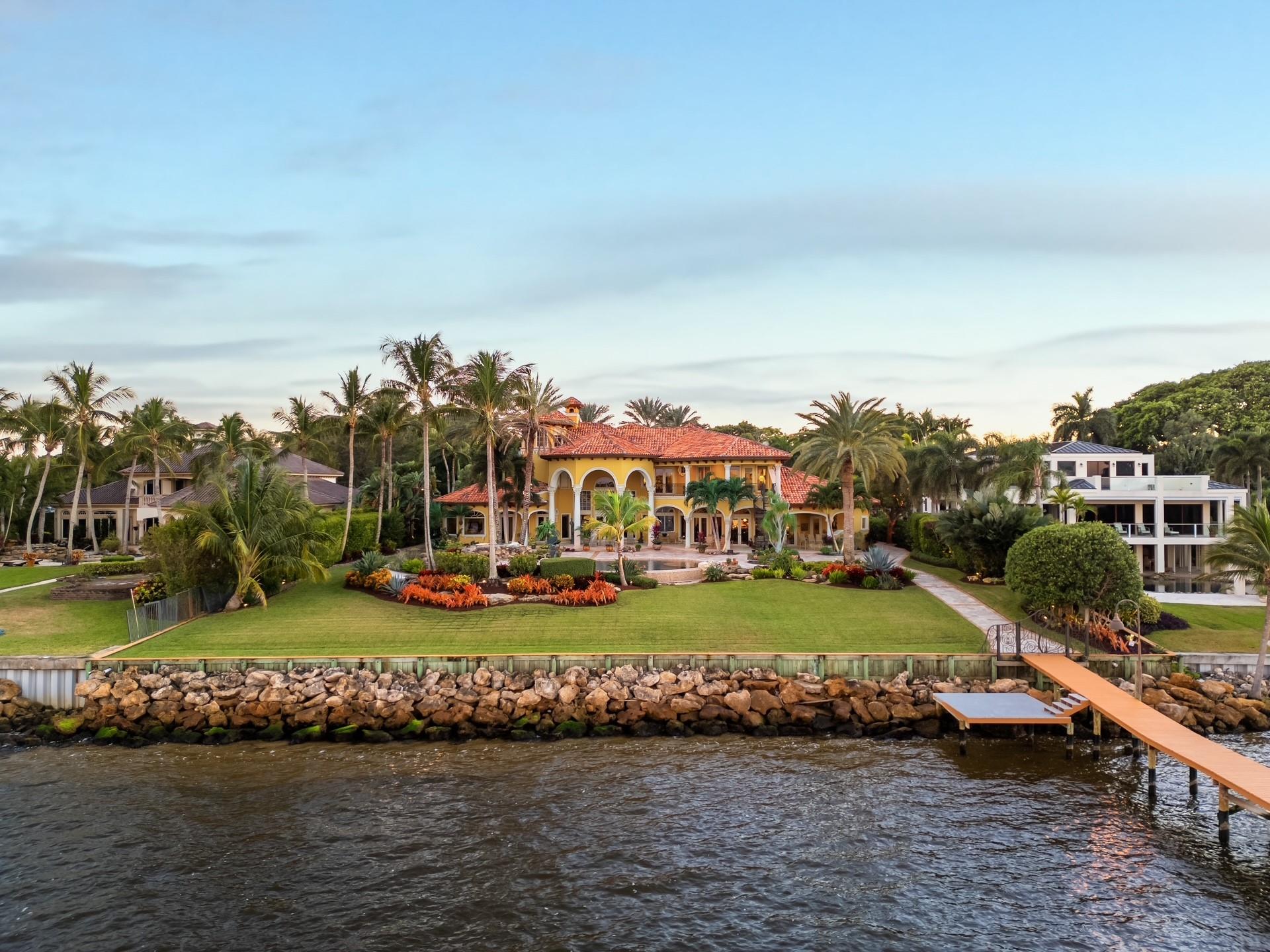 Discover the pinnacle of luxury in this custom-built waterfront estate in Stuart, FL. Spanning almost 13,000 total sq. ft. on well over an acre of prime real estate, this architectural masterpiece features 5 bedrooms, 7 bathrooms, a 5-car garage, and extraordinary custom woodworking throughout. The ground-floor primary bedroom offers light onyx countertops in the spa inspired en suite, dual closets, and stunning pool and waterfront views. Outdoors, enjoy an oversized pool, grotto, waterfall, and chef’s kitchen. A private dock includes 40,000 lb, 20,000 lb, and 12,000 lb lifts. The estate is introduced by a circular driveway with a grand fountain and covered portico. A private elevator and third-floor lookout tower with panoramic views complete this unparalleled offering. FLOOR PLAN IN PICS
