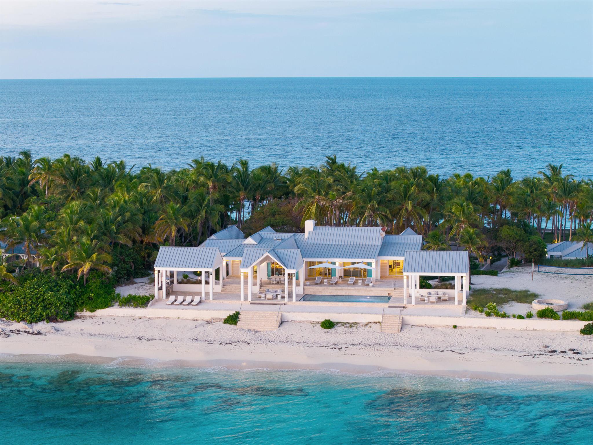 Introducing Twin Beaches, an extraordinary oceanfront estate nestled on one of the most coveted private islands in the Bahamas--Cat Cay. Encompassing a rare and oversized parcel of land with direct ocean frontage on both the eastern and western shores, this unparalleled property offers breathtaking sunrise and sunset views that frame each day in the most majestic light.Surrounded by lush tropical foliage and designed for effortless indoor-outdoor living, Twin Beaches is comprised of three distinct structures, thoughtfully arranged across the estate grounds to create a private, resort-style compound. The main residence features three spacious bedrooms and three and a half bathrooms, curated with elegant island finishes and panoramic water views. Just steps away, two separate guest hou