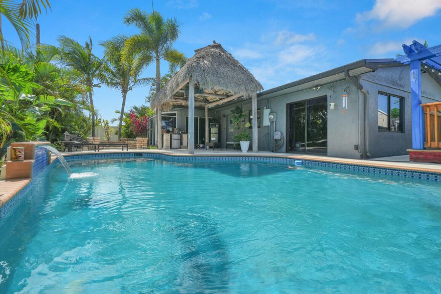 Discover your own South Florida retreat in Pompano Beach! This bright and inviting 3-bedroom, 2-bathroom home features an open living space filled with natural light and an enclosed Florida room perfect for relaxing, entertaining, or enjoying indoor-outdoor living year-round. Step outside to your own tropical oasis with a sparkling pool, charming gazebo, lush garden, and swaying palm trees creating the perfect setting for peaceful mornings or sunset evenings.  Conveniently located close to shopping, restaurants, and just a short drive to the beach, this home offers the ideal blend of comfort, privacy, and South Florida lifestyle.