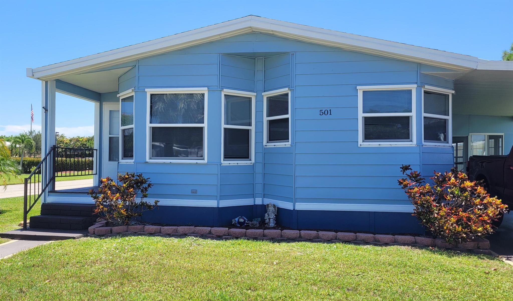 Pretty corner home in desirable 55+ community. NO LAND LEASE -YOU OWN THE LAND SHARE! 2Bd/2Ba. Lg sunny rooms. Newer double paned windows. Tile floors in common areas. Carpet in bedrooms. Large L-shaped kitchen with corner sink and adjoining breakfast room. Living room has a unique alcove that presently holds a TV. Can become a focus wall. Dining room features a built in breakfront and the bedrooms have large walk in closets. Master bath has a double sink, a garden tub with skylight and separate shower. Enclosed Florida room, Low monthly maintenance of $197. includes Cable TV, Hi Speed Internet, trash removal, use of club house and common grounds. You pay electric, water and lawn care. Let your flair for design explore the many possibilities of this home . All measurements approx.