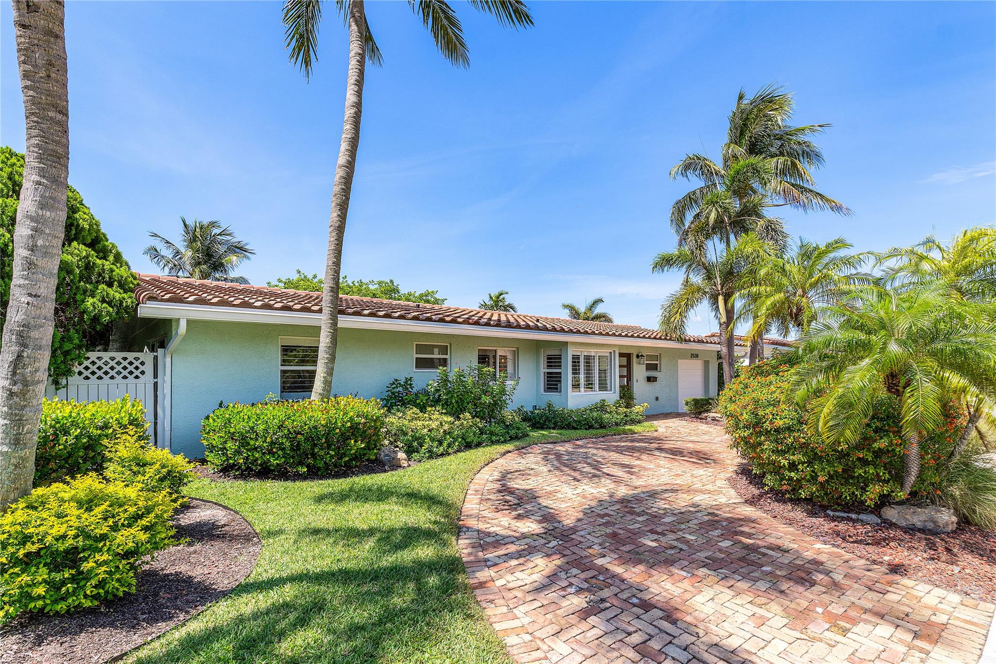 No detail left unturned in this 3 bedroom, 3 bath waterfront gem that has been completely transformed 4 years ago from the plumbing, electrical and insulation right up to the the 2023 roof! Features include designer kitchen with Sub Zero-Wolf appliances, quartzite counters, custom walk in pantry & laundry room, solid core doors, impact windows and sliders and neutral LVF flooring throughout. The primary bedroom offers a serene retreat, complete with sliding glass doors that lead to your tranquil pool, patio, and garden area. Southern exposure waterfront offers 80' of unobstructed ocean access, a 14,000# boat lift and seawall footer & batter piles installed in 2016. Just minutes to the Hillsboro Inlet...this home is the boater's paradise you've been waiting for!