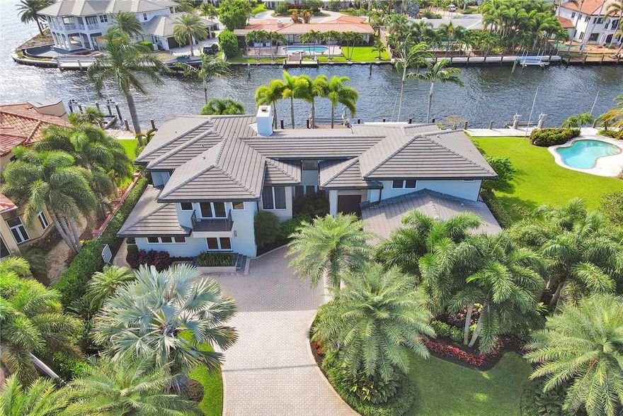 Magnificent completely renovated organic modern home w/ breathtaking Intracoastal views situated one from the point. Enter through the unique rotating front door into a bright volumed ceiling glass walled designer beauty. Custom Eat-in chefs kitchen w/ Subzero & Miele appliances overlooking family room. Lounge w/ full bar & Subzero wine towers, ideal for entertaining. Spacious downstairs office could be second primary bedroom. Upstairs is a custom primary bedroom suite w/ rotating television wall & sitting area. Spa style master bath w/programmable steam shower, jets & rain bath. 2nd oversized office w/lots of light & unique cork flooring. 2 additional guest suites. Southern exposure overlooking the deep water canal. Great outdoor entertaining w/heated saltwater pool, boatlift & bbq area