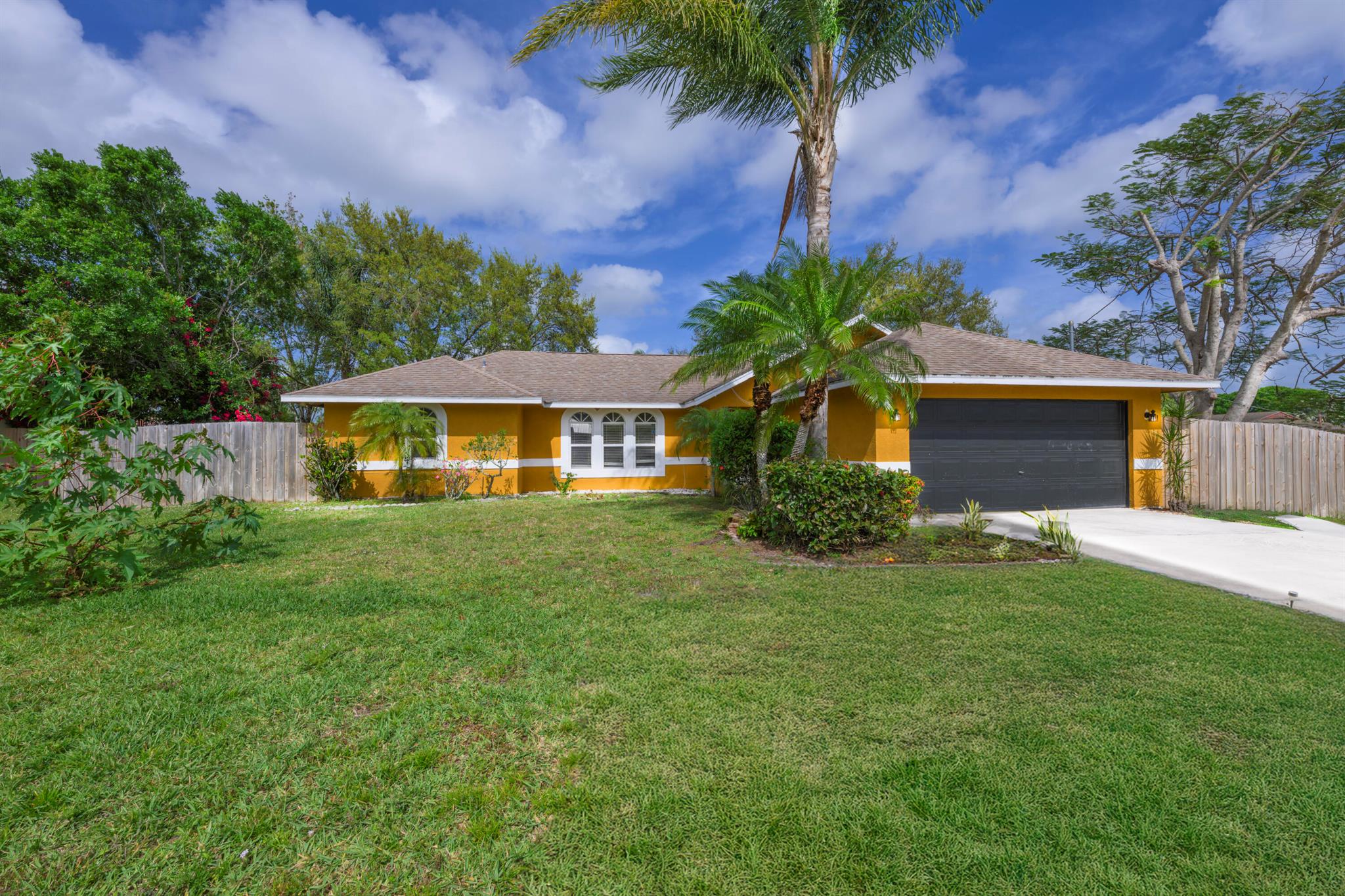 Situated on an Oversized Corner Lot! Discover this Immaculate 4 Bedroom, 2 Bathroom Home, centrally located in Port Saint Lucie, nestled in a quiet neighborhood! Roof- 2016, A/C- 2022, W/H- 2022! This Family Home has Natural Light beaming from every angle! Featuring an Open split floorplan, Vaulted ceilings in the main Living areas, Kitchen w/Breakfast Bar and passthrough Window, with Sliders/French Doors leading out to your Screened in Patio, Grilling area and huge backyard, with Mature Landscaping with a fenced yard and so much more! The Master Suite features an updated Shower w/Glass Doors, Bathtub, and a Walk-in closet! Great for entertaining, and room for a Pool! Very convenient to I95 and Tradition! All measurements are approximate and must be measured by tenant.