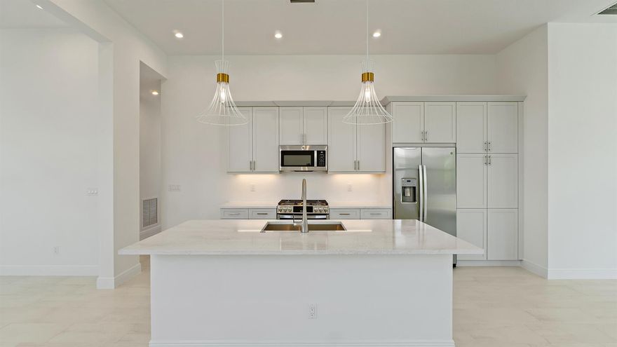 **NEW CONSTRUCTION** MOVE IN READY The Allison at Rivella is a 2-bedroom, 2-bathroom home that includes a Flex Room and a 2-car garage with a four-foot extension, providing additional storage and workspace. Situated on a Preserve view homesite with no homes behind, this residence offers a peaceful and private setting. The Great Room features 12' wide by 10' tall sliding glass doors, seamlessly connecting indoor and outdoor living while flooding the space with natural light. The kitchen is designed for both style and practicality, featuring Cambria quartz countertops, a counter-depth refrigerator, a double trash pullout, and under-cabinet lighting.