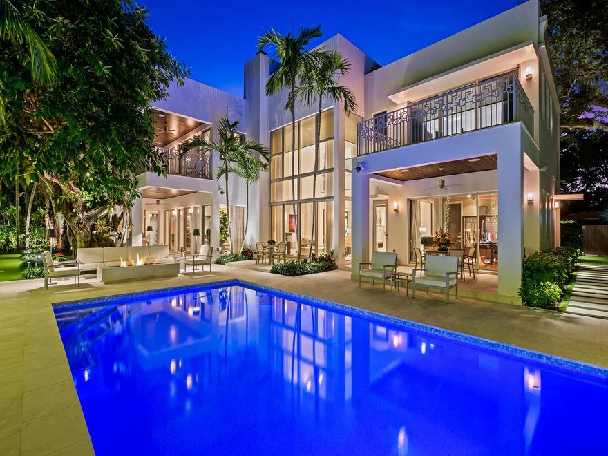 Luxury redefined in this gated & walled transitional contemporary waterfront estate, where every detail has been curated to deliver an elevated lifestyle w/unrivaled amenities & smart technology. The open concept flr plan & vol ceilings are illuminated by walls of glass that overlook an expansive tropical oasis, heated salt water pool, summer kitchen & 110' of deep water dockage. The 2 story living rm boasts a glass encased temp controlled 210 bottle wine rm. The custom kitchen is ideal for entertaining w/multiple islands, upgraded appliances & gas range. The lavish primary suite boasts, 2 spa inspired bathrms, 2 walk-in closets, pvt terrace & morning bar. Elevator, Home Generator & more. Feature list available. Walk to Las Olas Blvd, dining, shopping & the beach. Sq ft from IMAPP & seller