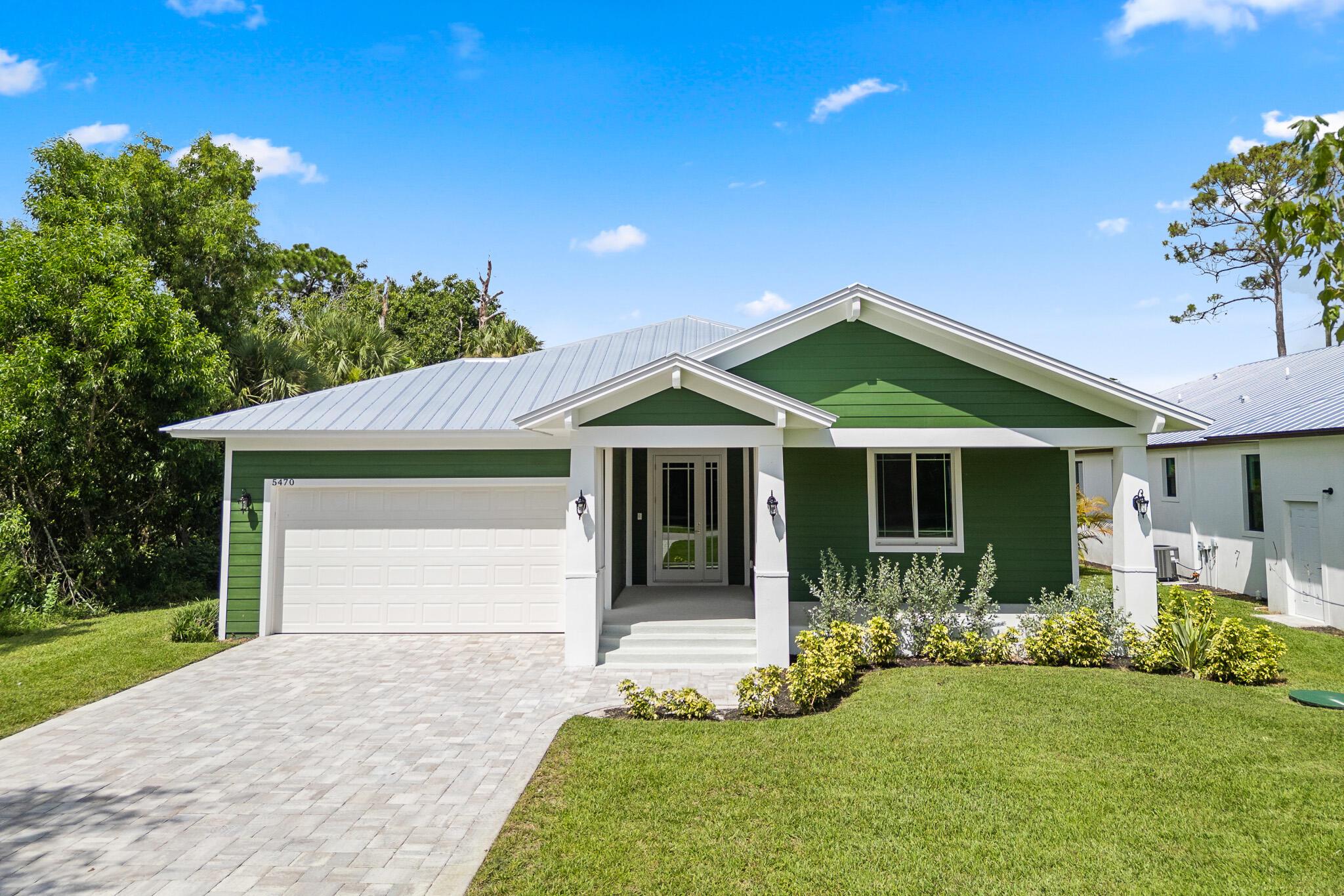 Where charm meets convenience, this thoughtfully designed 3BR, 2BA home blends luxury finishes with a warm, coastal feel. Built on a spacious lot just minutes from public boat ramps, Sandsprit Park and the historic Port Salerno waterfront district, this home offers the best of lifestyle and location. Enjoy open-concept living with quartz countertops, a waterfall eat-in island and wood cabinetry, complemented by luxury porcelain tile flooring throughout. Custom tray ceilings, recessed lighting, crown molding and ceiling fans create a serene ambiance. Impact windows and doors, metal roof and a stucco exterior offer peace of mind, while the elevated foundation provides great breezes and inviting front and rear patios. The oversized 10' garage door and ample lot space welcome your boat, RV, o