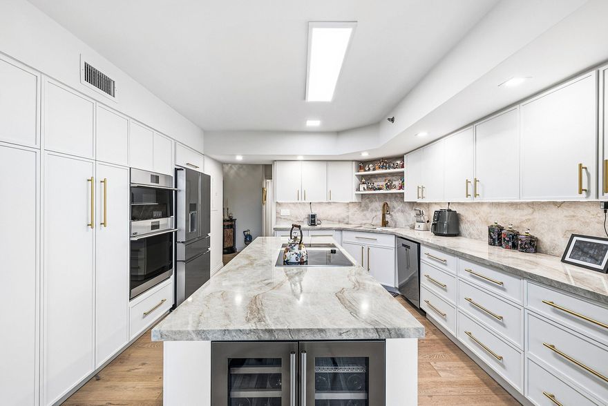 Located in a quiet gated enclave within Boca Pointe (non-mandatory club), this boutique building offers a semi-private entry shared by only two residences. All SIRS milestone inspections completed - NO ASSESSMENTS. Turnkey, fully HIGH-END renovated true 3BR + OFFICE condo with over 3,000 sq ft of sophisticated living in neutral tones. Features include rich hardwood floors, custom built-ins, modern wet bar, chef's kitchen with white shaker cabinetry, quartzite counters, GE Café appliances, double ovens, wine fridge & walk-in pantry, plus a large laundry room. Expansive primary suite with spa bath & golf views. Hurricane IMPACT windows/doors, new water heater, glass-enclosed sunroom, endless lake & golf vistas. Includes underground parking, storage, pool, spa, clubhouse & optional golf membership. See feature sheet under documents for more detail on this incredibly high end renovated property. Don't miss!