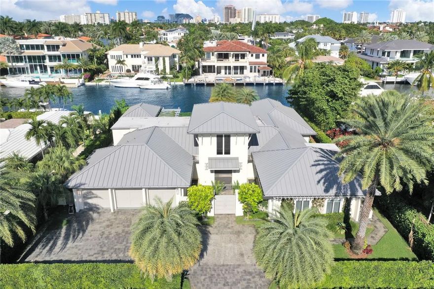 Spectacular one-story coastal modern home on one of the most exclusive waterways in Harbor Beach. Residence equipped with impeccable finishes, thoughtful interior design, 105 ft of water frontage on +/-140' wide canal, boat lift, and Azek composite dock. Eat-in kitchen with high end appliances, custom cabinetry and water views. Large master bedroom with vaulted ceilings, walk-in closet, dual vanities & soaking tub in master bath. Home built with NanaWall folding doors which seamlessly blend with the outdoor living area. Home also features lush landscaping, pool, spa, cabana bath, & outdoor summer kitchen with gazebo to enjoy the beautiful breezy days and nights. Private Harbor Beach Surf Club with 300 ft of beachfront & private marina membership available.