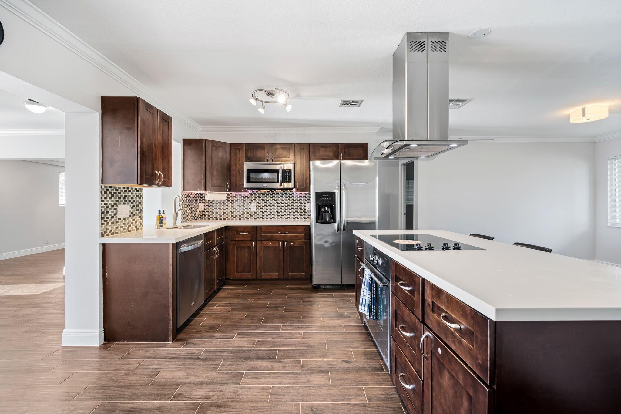 Welcome to this impeccably renovated single-family home located in the heart of Palm Beach Gardens. This 4-bedroom, 2-bathroom house offers modern style, comfort, and convenience in a prime location with no HOA. Step inside to a beautifully updated interior featuring brand-new flooring, fresh paint, and a completely remodeled kitchen with quartz countertops, stainless steel appliances, and custom cabinetry. The open-concept layout is perfect for entertaining, flowing seamlessly from the kitchen into the spacious living and dining areas. Enjoy the large, fenced backyard--ideal for outdoor gatherings, kids, or pets. The home also features a full-size laundry area, a carport, and a spacious driveway. Located just minutes from I-95, The Gardens Mall, restaurants, schools, and beaches.