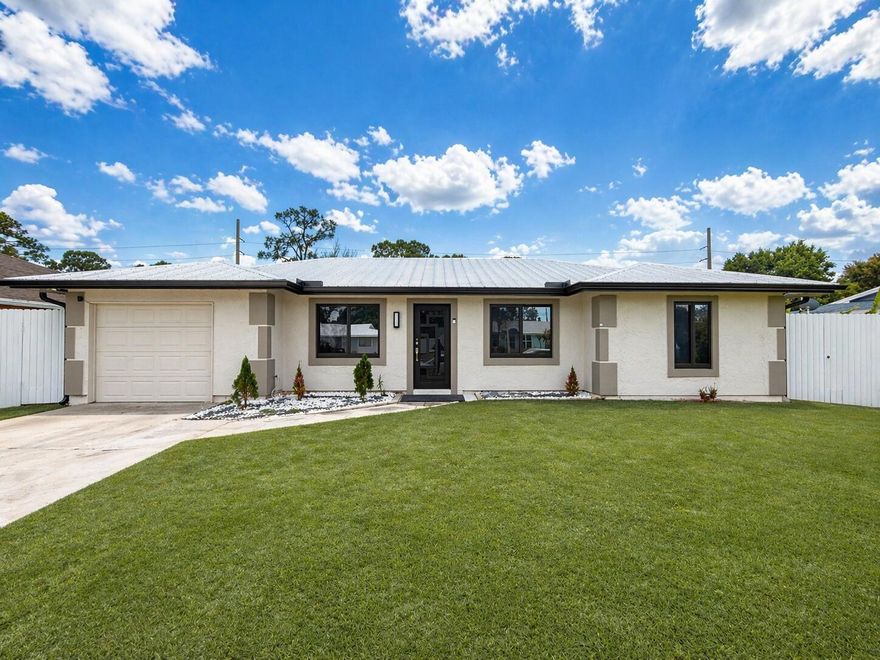 This thoughtfully renovated home offers comfort, versatility, and a prime location near shopping, dining, and top-rated schools.  Key updates include impact windows, a metal roof (2021), and ceramic tile flooring throughout. The luxurious primary bathroom features high-end finishes, while the spacious laundry room doubles effortlessly as a home office or fourth bedroom.  A private in-law suite with its own entrance provides ideal flexibility for extended family and guest. Outside, a storage shed and fully fenced yard with an 8-foot metal fence offer added privacy and functionality — all with no HOA restrictions.  Schedule your private showing today.