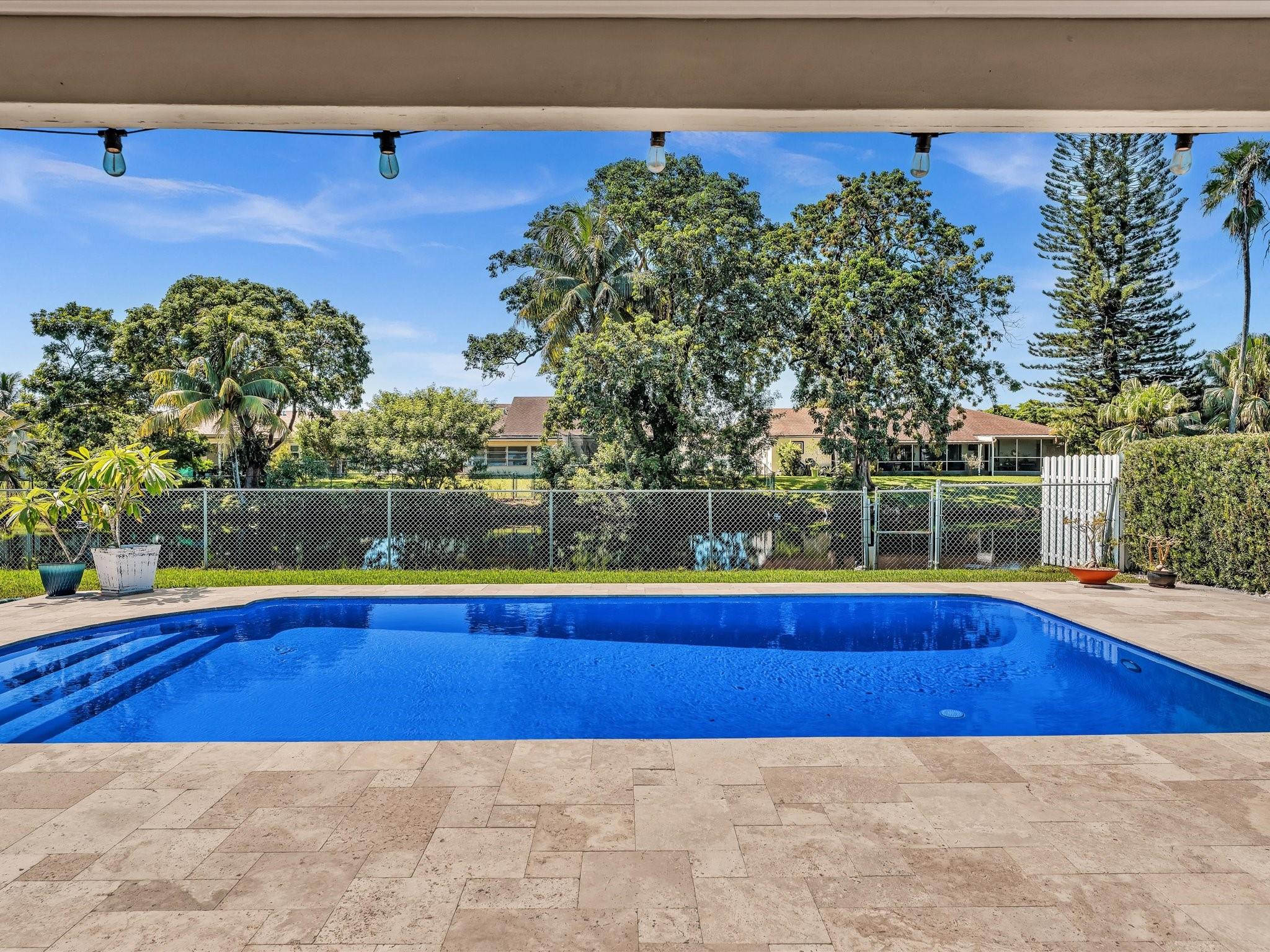 Rock Star Beautiful - Located Down the Street - Soccer Club Park! Immaculately Maintained Waterfront Home Has It ALL, Sophisticated Alarm / Video Surveillance along w/ all Smart Home Features and Technology of 2025! No HOA! Kitchen is a Chef's Dream - Remodeled 2018 - Bathroom Remodeled 2024 - Crown Molding - Porcelain Plank Flooring w/6 inch baseboards -2024 A/C 4 Ton - 2017 Roof - Entertainment Bar has built in Wine Rack. Split Bedroom Floor Plan-Great Pool Parties on Travertine Patio and Pool Deck-Salt Water Pool Recently Diamond Bright. Fully Fenced Yard - New Shed- 2025 Canal Fed Sprinklers - Great Fishing in Back Yard! Impressive Water Softener and Filtration System. 100% Hurricane Impact - New Electrical Panel-Garage has Custom Wall Storage Systems -Expanded Driveway 6-8 Cars