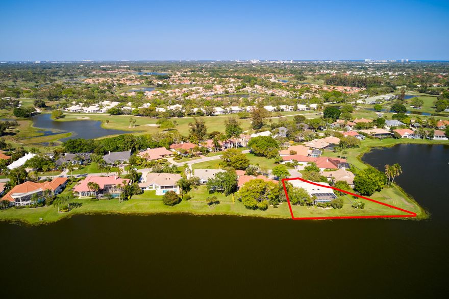 Tucked away on a quiet cul-de-sac in the Preston community of PGA National, this well-maintained single-family residence offers 3 bedrooms, 3.5 bathrooms, a dedicated office, and 3,390 square feet of living space under air on an expansive 19,902 square foot lakefront lot. With a spacious layout and inviting feel throughout, the home presents an exceptional opportunity for a buyer to update and personalize to their own style. The true highlight is the inviting outdoor living area, designed for both relaxation and entertaining. An expansive covered patio features distinct spaces for dining, lounging, and gathering, complemented by a built-in grill and sink set within a convenient outdoor prep area, with additional space below for a small refrigerator. Just beyond, a screened enclosure houses the pool and spa, creating a seamless indoor-outdoor experience. Outside of the enclosure, the fully fenced yard is bordered by a mature hedge for added privacy, while still offering additional green space and tranquil lake views beyond. The property's southeastern exposure welcomes an almost constant breeze, while the backyard setting provides the perfect vantage point for photo-worthy sunsets. The lake also attracts a variety of native wildlife, including sandhill cranes and herons, creating a dynamic and ever-changing natural backdrop. Inside, the family room offers a warm and inviting focal point with a working fireplace framed by custom built-in shelves and cabinetry. The home has been consistently cared for, with notable updates including A/C units (2016 & 2017), water heater (2020), kitchen appliances (2015), and a pool pump (2025). Additional features include a spacious laundry room with sink and ample cabinetry, generous closet space throughout, an in-house vacuum system, and a combination of accordion and panel shutters for storm protection. Offering great bones, a premier lot, and endless potential, this property is an ideal canvas for creating a custom home in one of Palm Beach Gardens' most sought-after communities.