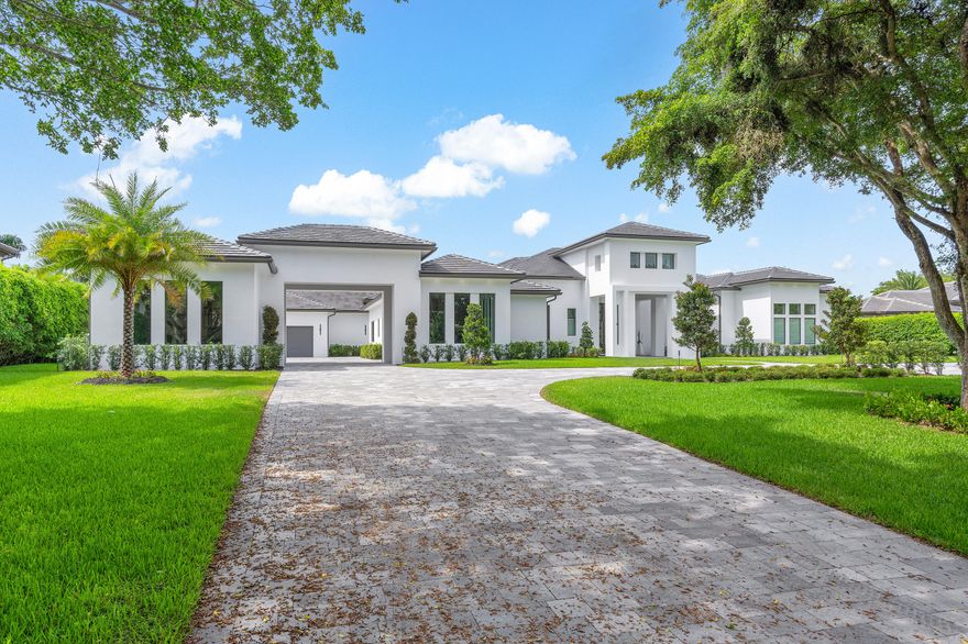 This contemporary, newly completed home offers luxurious living on 200 feet of waterfrontage, in guard gated Long Lake Estates. A grand circular paver driveway welcomes you, leading to the homes hidden 6-car garage. Six bedroom suites, each with private bathrooms, light-filled windows, and  walk-in closets. The primary suite is expansive, with lake views, a grand bathroom with steam shower, and enormous closets.   This custom plan featured a three-way split floor plan, with three distinct living spaces. First, a welcoming formal living room with library and grand dining space, then the spectacular kitchen with dinette, and family room. Finally, a voluminous club room, with spaces for billiards, media, bar and more. The grand kitchen sports twin islands, commercial grade appliances and expansive storage. Outside, you'll find a large covered loggia with summer kitchen, 40x18 heated saltwater pool, a paver patio, and large grassed areas for recreation and privacy.