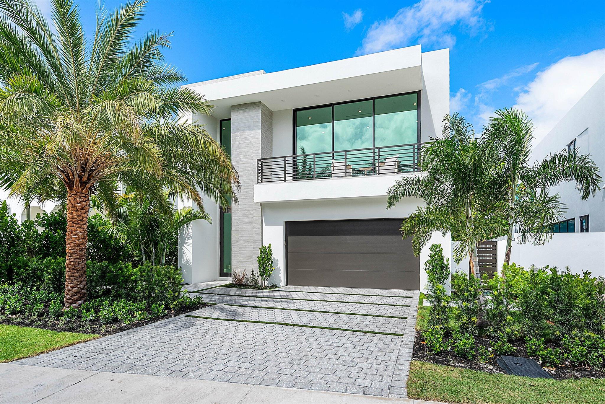 Welcome to Hamelia House, a curated haven by Stamm Development Group, perfectly situated in one of East Delray's most desirable zip codes. This 4-bedroom, 4.5-bath residence offers 3,556 square feet of thoughtfully designed living space, with a total of 4,989 square feet under roof. Every detail of this home has been crafted for seamless indoor-outdoor living, blending sophistication with comfort for both entertaining and relaxation.On the first level, a stunning formal dining room flows effortlessly into the open living area, where floor-to-ceiling sliders invite you to the outdoors. The sleek, neutral-toned kitchen--equipped with premium Thermador appliances, including an 8-burner range--caters to the most discerning chef.