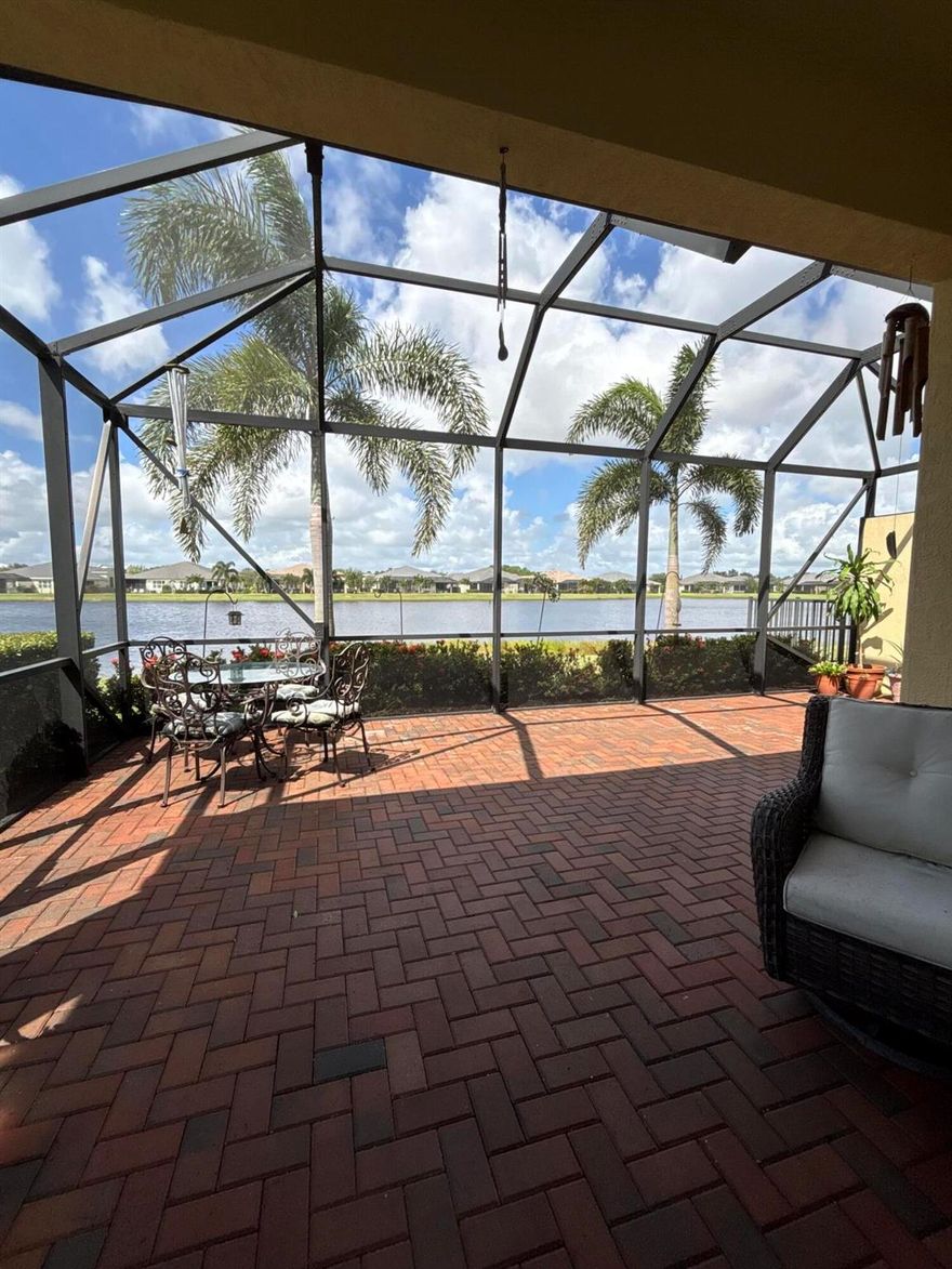 BUILT IN 2021, this IMMACULATE 55+ villa offers 2 bedrooms, a DEDICATED OFFICE WITH ELEGANT FRENCH DOORS, and a separate laundry room. The open layout features soaring ceilings, a BEAUTIFUL SPACIOUS KITCHEN, with Quartz Countertops, a Large Island, Stainless Steel Appliances, Plantation Shutters, and Hurricane Impact Windows for peace of mind. Enjoy STUNNING LAKE VIEWS from your oversized screened patio, perfect for entertaining or relaxing. A 2-car garage adds convenience, while NATURAL LIGHT FILLS EVERY ROOM, creating a warm, inviting feel. Located in the quiet gated community of LAKE PARK AT TRADITION.!! You'll enjoy Resort-Style Amenities and a Vibrant Lifestyle. It's time to ENJOY YOUR LIFE..! Call today for your private tour!