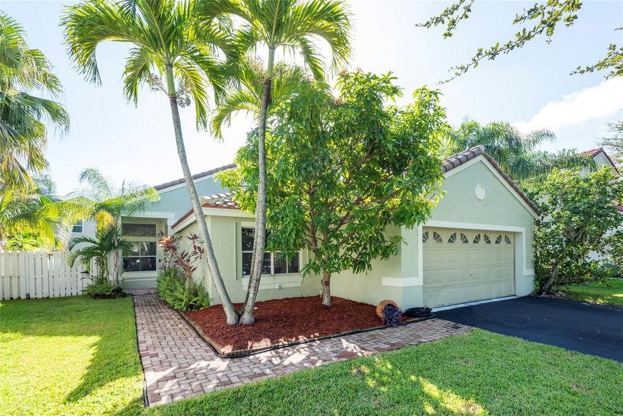 Welcome to The Lakes, a centrally located, gated, family community in the heart of Weston. This enticing 3 bedroom, 2 bathroom single family home with a 2 car garage features a fully fenced-in and very private yard with a beautiful free form heated swimming pool with waterfall and spa. Large pool patio-excellent for entertaining. Home includes fresh neutral paint throughout, new flooring in all the bedrooms, and a remodelled kitchen with wood cabinetry, granite countertops & stainless steel appliances. Master bedroom has volume ceilings, walk-in closet with built-in cabinetry, double sinks, separate shower & roman tub plus private WC. Large great room social areas overlooking pool area.  Social areas are tiled and feature volume ceilings. Roof (2022), A/C (2024), New plumbing (2024-25)!
