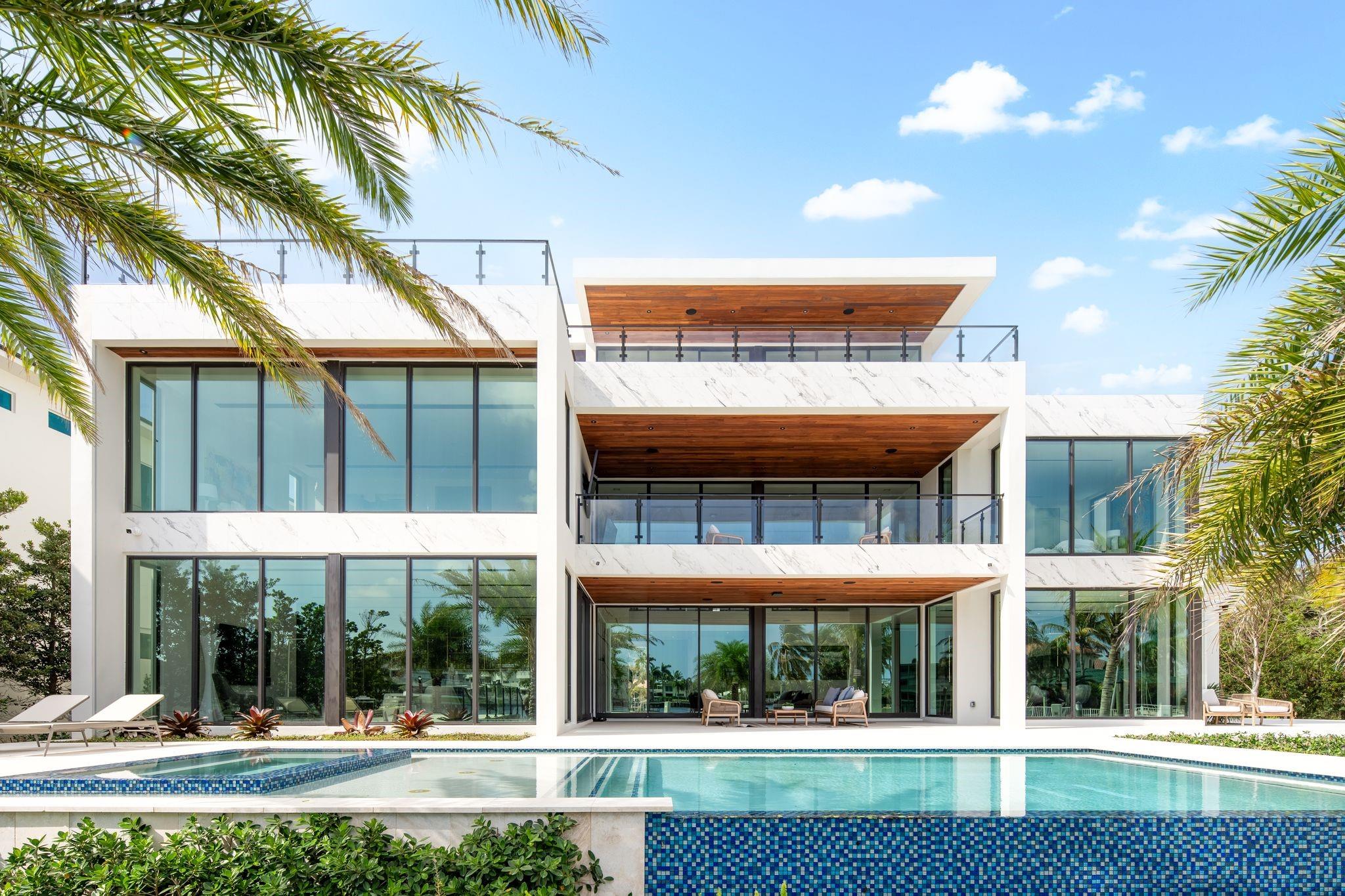 This 3 story custom masterpiece truly has it all. The moment you step through the oversized pivot door you are greeted w/ double high ceilings & oversized glass sliders offering a picturesque view of the intracoastal. The home is perfectly situated providing breathtaking views from almost every space across all 3 floors. An elevator provides easy access and your garage has ceiling height to allow for a lift. A Control 4 system manages your full spectrum ColorBeam lights, Lutron Shades & concert quality sound inside & out. Your concrete dock offers 3 Power Pedestals & 140'+ straight to accommodate your yacht(s). A summer kitchen complete w/ smoker, ice maker, and fridge right outside your kitchen. A full-home Generac Solar system w/ 3 power banks provides further peace of mind.