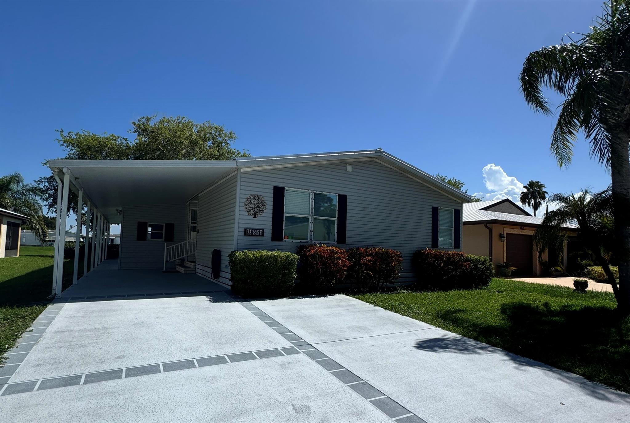 Lovely lake view home in the desirable 55+community of Spanish Lakes Fairways.Home is a 3 bedroom 2 bath. Home has large air conditioned Florida room off back of home over looking the lake. Covered patio off the east side of home perfect for enjoying morning coffee or evening cocktails. Large kitchen with eat in kitchen and desk area. Home is a split floor plan with 2 spacious bedrooms in front of home. Home has shed in rear of home. New deck with Trek wood off west side of home. New metal roof 2024. Flooring is carpet and laminate. Primary suite bathroom has double vanities as well as shower and tub. Laundry is inside of home. Lawn care, trash removal and golf included in lot rent.18 hole golf course,2 pools, tennis, pickleball, bocce ball, shuffle board and much more. Must See