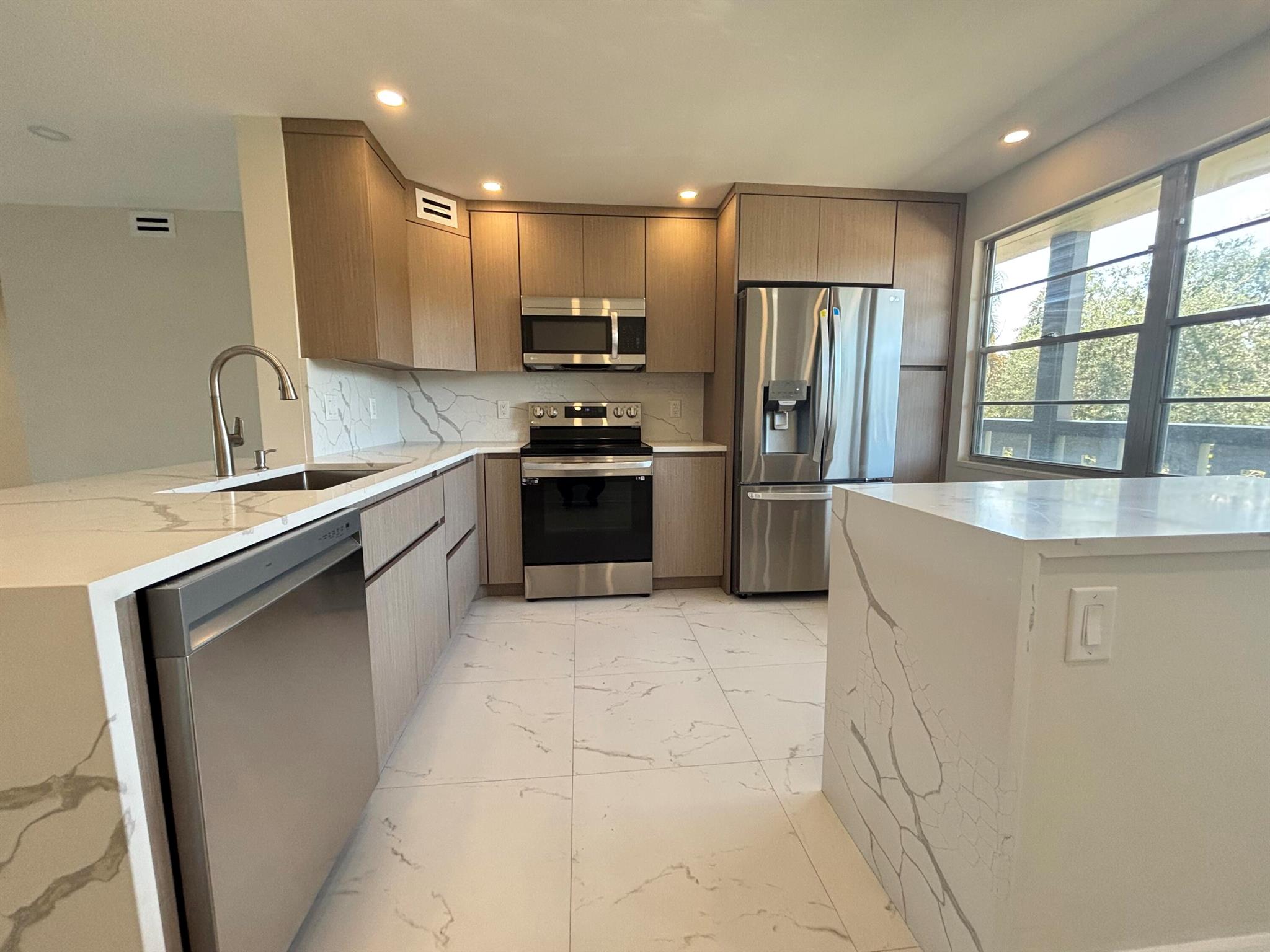 Fully renovated 2BD/2BA condo in Wynmoor for just $199,900! This 3rd-floor unit (with elevator) features an open kitchen with new cabinets, quartz countertops, stainless steel appliances, and porcelain floors throughout. Smooth ceilings with recessed lighting, upgraded bathrooms with new showers, vanities, mirrors, and toilets, plus fans in every room. Enjoy serene lake & fountain views from your private balcony. All renovations completed with permits. Wynmoor 55+ community offers resort-style amenities: pools, pickleball, tennis, golf, theater, restaurant & more! Assoc. requires 20% down & one occupant 55+