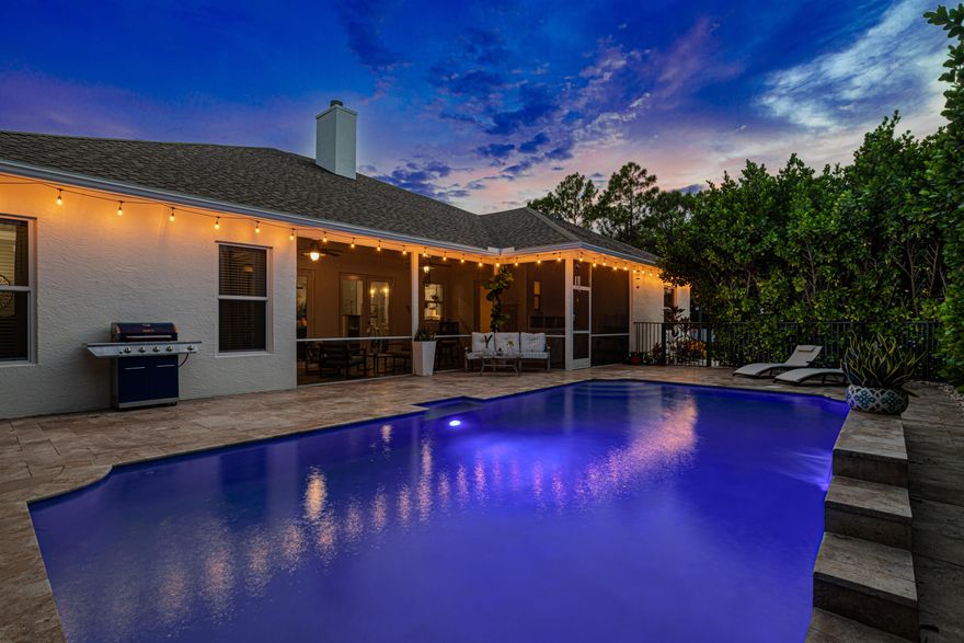 Recently refreshed and thoughtfully repositioned, this impeccably renovated Modern Farmhouse estate offers exceptional value on a private 1.15-acre fully fenced parcel in Loxahatchee. Featuring 4 bedrooms, a dedicated office/den, 3 full baths, and an oversized 2-car garage, this move-in-ready residence delivers the ideal balance of space, privacy, and modern design—without the limitations of a managed community. Vaulted ceilings and wood-look flooring enhance the open living areas, anchored by a striking double-sided fireplace that connects the main living and entertaining spaces. The kitchen is designed to impress, with quartz countertops, an oversized island, custom 42'' cabinetry, premium appliances, and a built-in wine cooler—perfect for both everyday living and hosting. Built for long-term comfort and efficiency, the home includes impact windows and doors, a newer HVAC system, and whole-house reverse osmosis water filtration. The outdoor setting offers a true private retreat. A screened lanai overlooks the saltwater pool with waterfall feature, surrounded by mature hedging and lush landscaping for added privacy. The property also features a prepared vegetable and herb garden, along with a renovated 20x10 detached structure ideal for a home office, fitness space, or studio. A secondary storage building provides added convenience, with equipment included. Enjoy the flexibility to utilize your property to suit your lifestyle, with ample space for recreational vehicles, boats, or future enhancements. Ideally located just minutes from the Shoppes of Westlake and the future Avenir Town Center, this property combines peaceful acreage living with easy access to dining, shopping, and ongoing development. With its extensive upgrades, functional layout, and recent price adjustment, this home represents a compelling opportunity within the acreage market. Furniture negotiable.