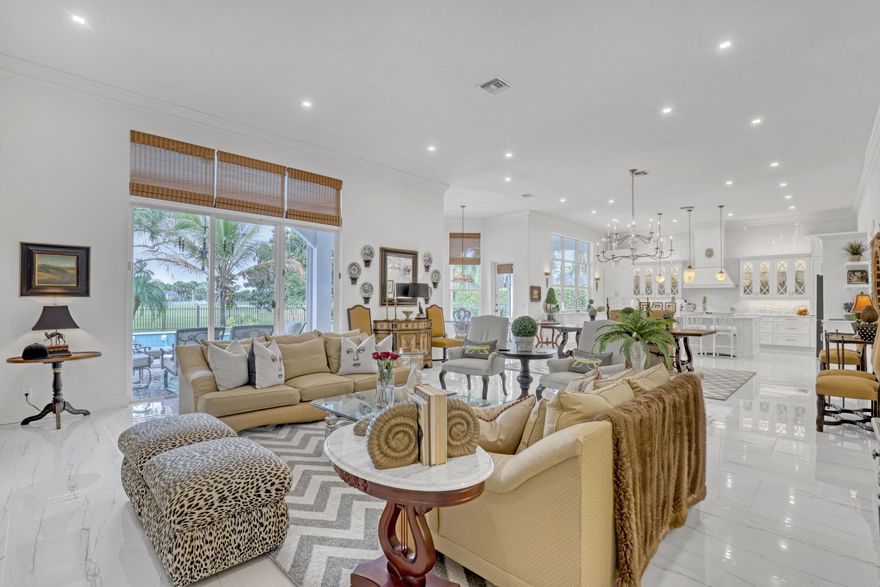 Rarely available, this beautifully renovated 5 bedroom estate in Ironhorse is set on nearly ½ acre and uniquely positioned with no neighbors in front or behind, offering exceptional privacy and sweeping golf course views. Located in a prestigious 24/7 guard-gated, non-mandatory golf community with low POA fees of just $310/month, and ideally situated close to shopping, dining, the Turnpike, I-95, and Palm Beach International Airport. Designed for both everyday living and entertaining, the home features a spectacular 1,050-square-foot great room centered around a custom kitchen showcasing a La Cornue gas range, quartz countertops, elegant cabinetry with glass accents, designer hardware, 35 soft-close drawers, and an impressive 11'2" x 5'5" island with breathtaking views.... (see supplement) of the pool, garden, and golf course. The open layout flows seamlessly into a spacious dining area, a charming breakfast nook in a bay window, and an expansive living room with 12 foot ceilings, 10'6" sliding glass doors, and transom windows, filling the home with natural light. The primary suite is a true retreat, offering a generous sitting area overlooking the pool and golf course. The spa-inspired primary bathroom features a walk-in shower with multiple shower heads, handhelds, rain head, and body sprays, along with custom vanities and a freestanding soaking tub. All secondary bathrooms have been fully renovated, and porcelain tile flooring runs throughout the home. Outdoor living is equally impressive, with two covered loggias measuring 22' x 12' and 16' x 12', perfect for entertaining while enjoying the pool, lush landscaping, golf views, and stunning sunsets.