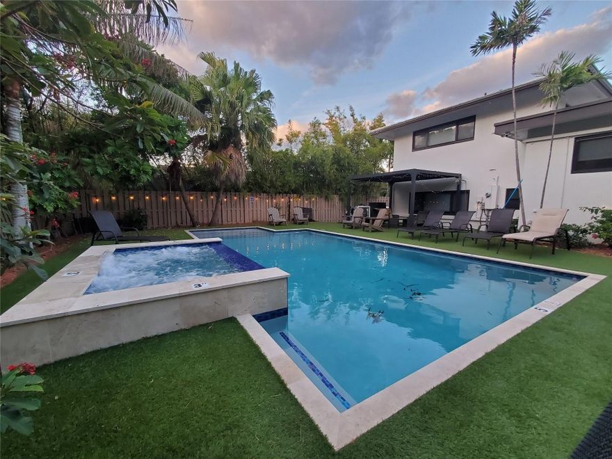 Discover coastal living in this beautifully updated 3-bedroom, 3-bath home in East Fort Lauderdale, just steps from the beach. Set in a premier neighborhood, this residence features soaring ceilings, bright open spaces, and floor-to-ceiling windows with views of a lush, fenced garden oasis.The newly installed heated pool, spa, and hot tub are surrounded by tropical landscaping—perfect for relaxing or entertaining. Enjoy exclusive beach access only 0.5 miles away, plus close proximity to top shopping, dining, Port Everglades, the convention center, and more.This refined retreat offers an ideal blend of privacy, elegance, and convenience in one exceptional package. From Pool controls to Lighting SMART controlled. All new AC units in every room. Roof serviced and washed 12/2025 .