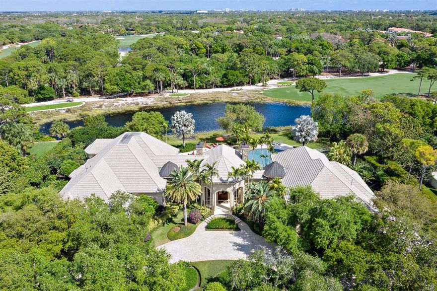 *We encourage you to view the photo tours, as descriptive space is limited*  Something special happened when Lavelle Construction,  Affiniti Architects, Krent Wieland Landscape Design, Decorators Unlimited and passionate & knowledgeable owners collaborated to create 114 Bears Club Drive. The single level French style home is peacefully situated on 1.25 acres and 150' of frontage, offering lake and fairway views, while affording ample setback for additional privacy...and barely even a glimpse of any home in the distance.   The charm of this home greets you upon entering the circular drive, lined with mature oaks, bougainvillea and orchid adorned palms, to the smart blend of fieldstone exterior, mahogany & glass entry doors and gently cascading waterfall. Expansive palladium windows offer a sneak peek of the lagoon style pool and spa area, as well as separating the master wing from the main living areas.  Master wing features include a spacious study, complete with custom cabinetry and French doors to the pool.  Beautiful windows frame the seating area in the master suite, while French doors lead you to a private, romantic lanai, overlooking the pool and spa.  Enjoy fully equipped his and hers private baths and dressing areas, as well as the exercise room and master wing 2 car garage!  The guest area is spacious and loaded with quality but this pool...this lagoon style pool is awe inspiring.  Multiple rock waterfalls and landscape areas offer serenity and numerous opportunities for outdoor enjoyment.  Plenty of room to sunbathe or soak in the spa, while observing  the regularly visiting bald eagle as he/she sizes up the next seafood lunch.  The spacious lanai has ample room for a dinner party and is just steps away from the nicely equipped summer kitchen.  The casual portion of the interior features a chef's kitchen, with commercial grade natural gas range, multiple sinks, warming drawer and butler's pantry.  The snack bar and breakfast room open to a cozy family room, highlighted by a tongue & groove wood octagonal ceiling, with antiqued beams.  For more fun, step into the billiard and pub room, all professionally outfitted and trimmed with rich wood accents from floor to ceiling.  Cap off your fun days by watching a favorite movie or sporting event on the big screen in your sound insulated media room.  The balance of this wing includes 3 luxurious and unique guest suites, all complete with private baths.  This wing also has an attached 2 car garage, bringing the total to 4 air conditioned garage spaces.  We hope to see you at this very special and lovingly cared for home soon!