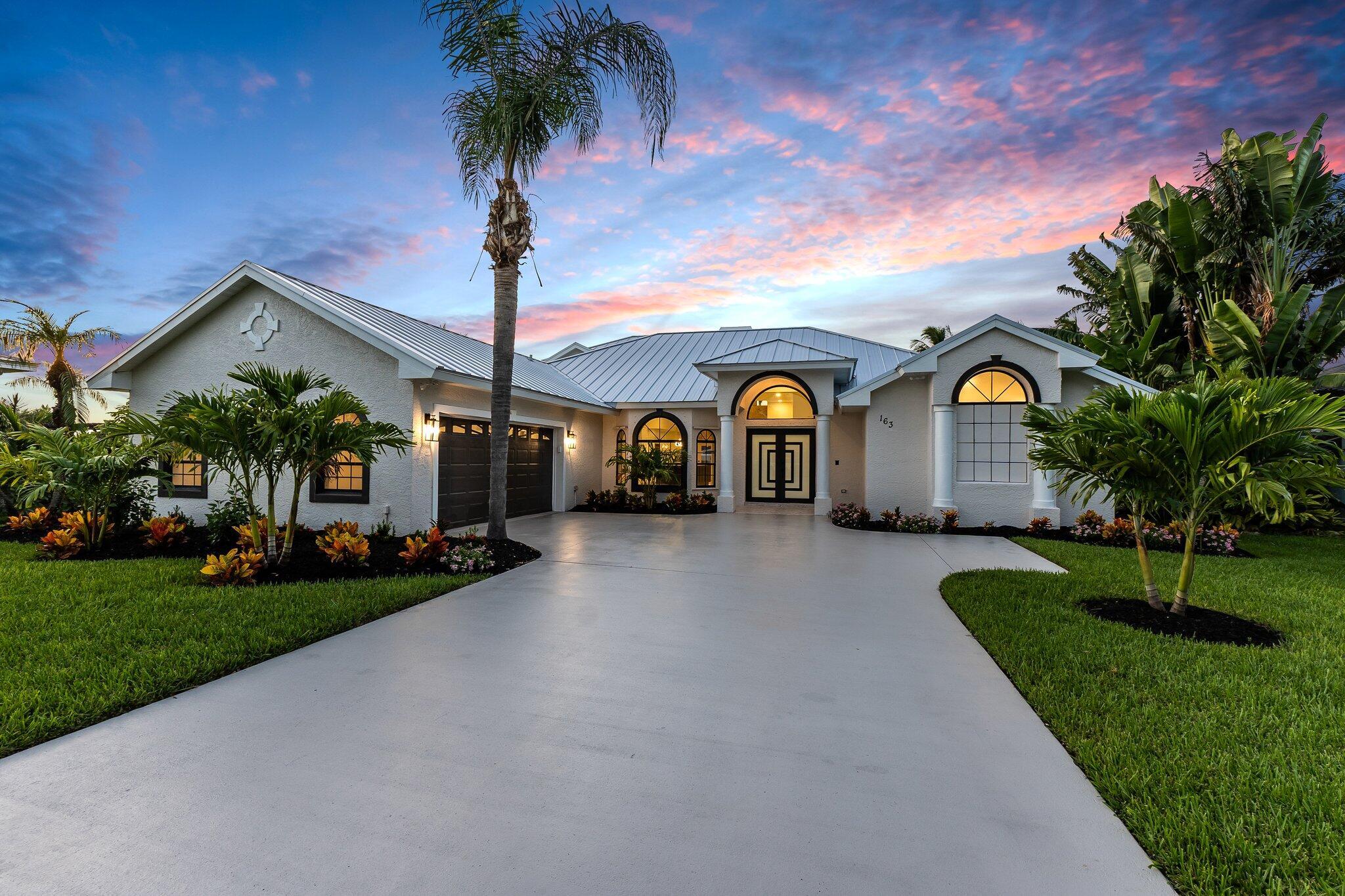 Nestled in the exclusive gated community of Osprey Ridge, this spectacular waterfront masterpiece has been completely remodeled to perfection. A new metal roof and two new AC units ensure comfort and longevity. Step through custom double doors into an open-concept design adorned with stunning 48x24 porcelain tile. The heart of this home is the chef's kitchen, featuring a 15x5 quartz island, high-end cabinetry, and top-tier appliances. A separate bar with a wine cooler enhances the entertainment experience. The family room, highlighted by a coral wall and fireplace, exudes warmth and elegance. Outside, a covered travertine patio leads to a newly resurfaced screened-in pool and spa. Situated on over half an acre with breathtaking water views, enjoy serenity on your private dock and party d