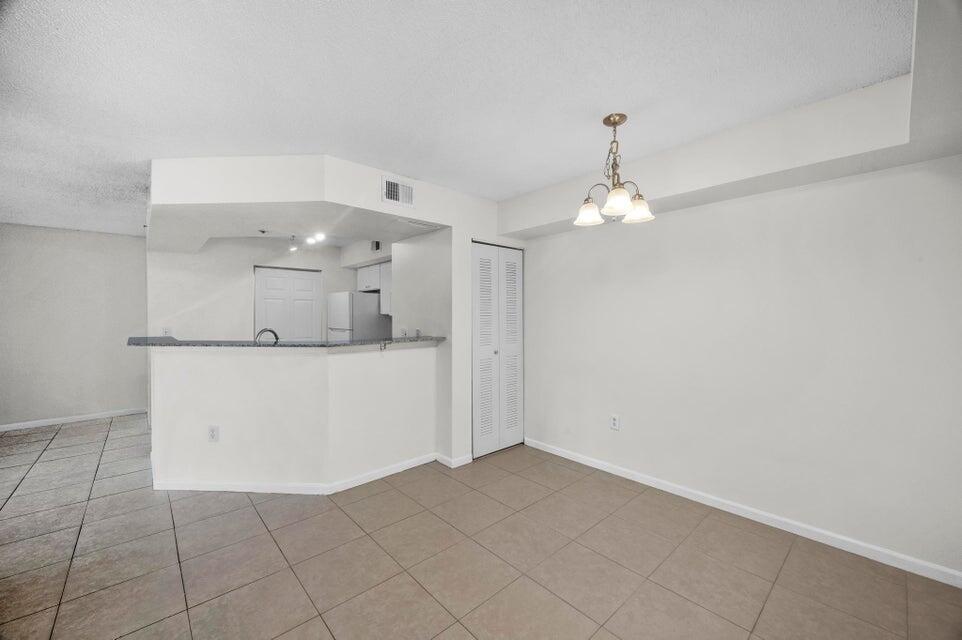 Awesome Updated 1BR/1BA Condo in Resort-Style Gated Community! Beautifully updated 1 bed/ 1 bath condo located in the heart of Jensen Beach. Features: eat-in kitchen with modern finishes and granite countertops, tile and vinyl flooring throughout (no carpet), an updated bathroom, in-unit laundry room, and a screened-in patio. Enjoy resort-style living with access to tennis courts, a community pool and hot tub, racquetball court, fitness center, and playground. This gated community offers exceptional amenities and unbeatable convenience -- just minutes from Downtown Jensen Beach, Treasure Coast Mall, dining, shopping, and the beach. One pet may be considered by landlord with a non-refundable pet fee. First, last, and security deposit required. Application required. Available AUG 1st.