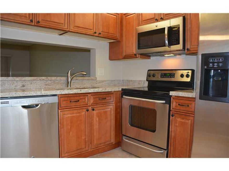 Waterfront REMODELED, PRISINE, 2 bedroom, split floor plan, ALL AGES, PET FRIENDLY condo in Coral Springs! Superior finishes--GRANITE, beautiful kitchen cabinets w/ soft closing cabinet doors, STAINLESS STEEL appl, tile throughout (incl screen enclosed pa tio). Eat-in kit w/ bkft bar, updated baths, lots of storage. Washer/Dryer hook-up inside condo. Steps from parking space to the front door & steps to pool. Tranquil, private views of expansive lush lawn & the waterway from inside condo--very PICTURESQUE!