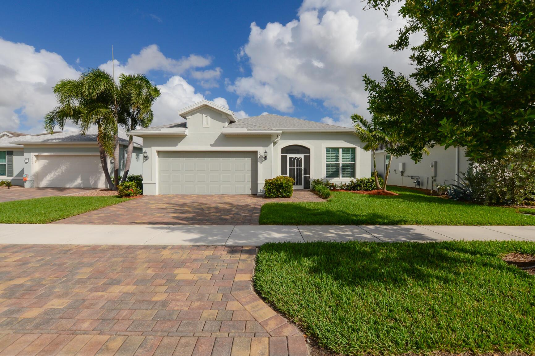 Beautiful Home in Del Webb at Tradition (55+ Community). Features 2 BR's, 2 BA's, Den/office with desk & built'in's, 2.5 CG w/room for a golf cart. Front Patio & Screen enclosed Lanai w/ aluminum Hurricane shutters & fantastic Lake View! CBS Construction, Impact Windows & Doors, Fabulous Open Floor Plan with lovely Kitchen boasting LG Island, 42'' white cabinets, Stainless steel appliances, gas range, walk in pantry, coffee bar, granite countertops, subway tile backsplash & Perfect for entertaining! Details include Tile throughout that looks like wood, Plantation Shutters, Crown Molding & custom built-in's. Split floor plan offers Master Suite Large walk in closet w/built-in's & MB offers dual sink & LG walk in shower with handicap bar. Generator, A/C in Garage & epoxy flooring.