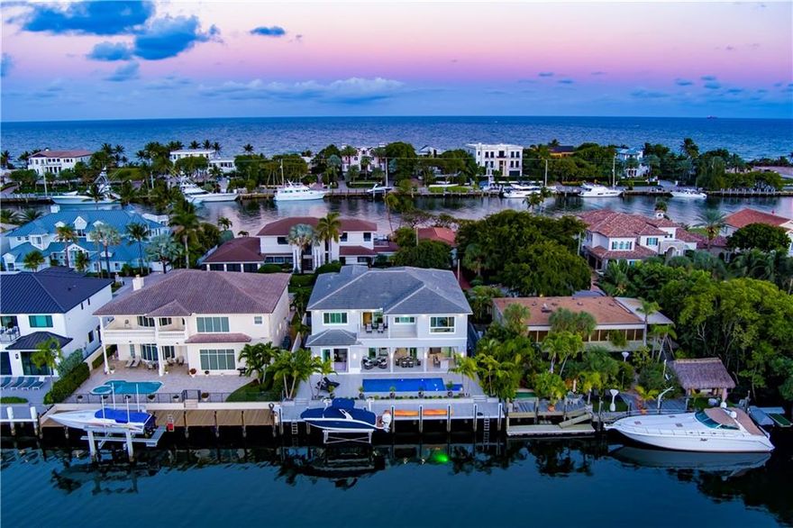 Gated Coastal-Contemporary Deepwater Estate sited on 75' +/- of waterfrontage with wide, spell-binding views of Lake Placid on Lighthouse Point’s prestigious Intracoastal Drive. Built by renowned Zahn Builders, this exceptional like-new estate features impressive light-filled interiors from nearly every major room. Modern, chef’s kitchen with top of the line SS appliances. A 2nd level master suite with dual walk in closets accompany four guest bedrooms all with en-suite baths. Luxe amenities include elevator, chilled wine display, upgraded Savant home automation, 12’ ceilings and more. Outdoor entertaining is enjoyed at the expansive covered loggia with roll down screens and resort-style pool with spill-over spa. 75+/- yacht dock minutes to the Hillsboro Inlet for the avid boater.
