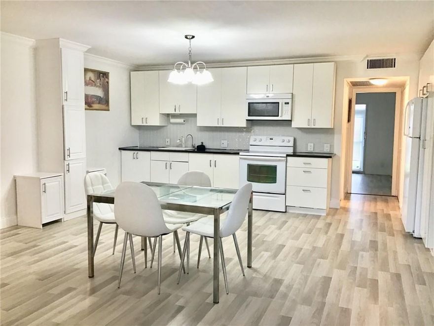 Rarely available open floor first floor unit that gets plenty of sunlight! Very spacious living room/dining room/kitchen combo. The unit is newly painted with an updated kitchen and built in storage cabinets with glass backsplash. Completely tiled with a Crown Molding throughout. Fully updated bathroom with a walk-in shower thats fully tiled with glass inlays and modern vanities. Powder room is also updated. Nice walkout patio/florida room in the back of the unit with grass and garden views. Very quiet and peacefull building. Comes with one assigned parking spot. Fanshaw has a large outdoor pool. Community is Gated and secured with a large clubhouse, 2 olympic size pools, exersize room, billiard rooms, ping pong, movie theater and many other daily activities! This unit won't last!!!