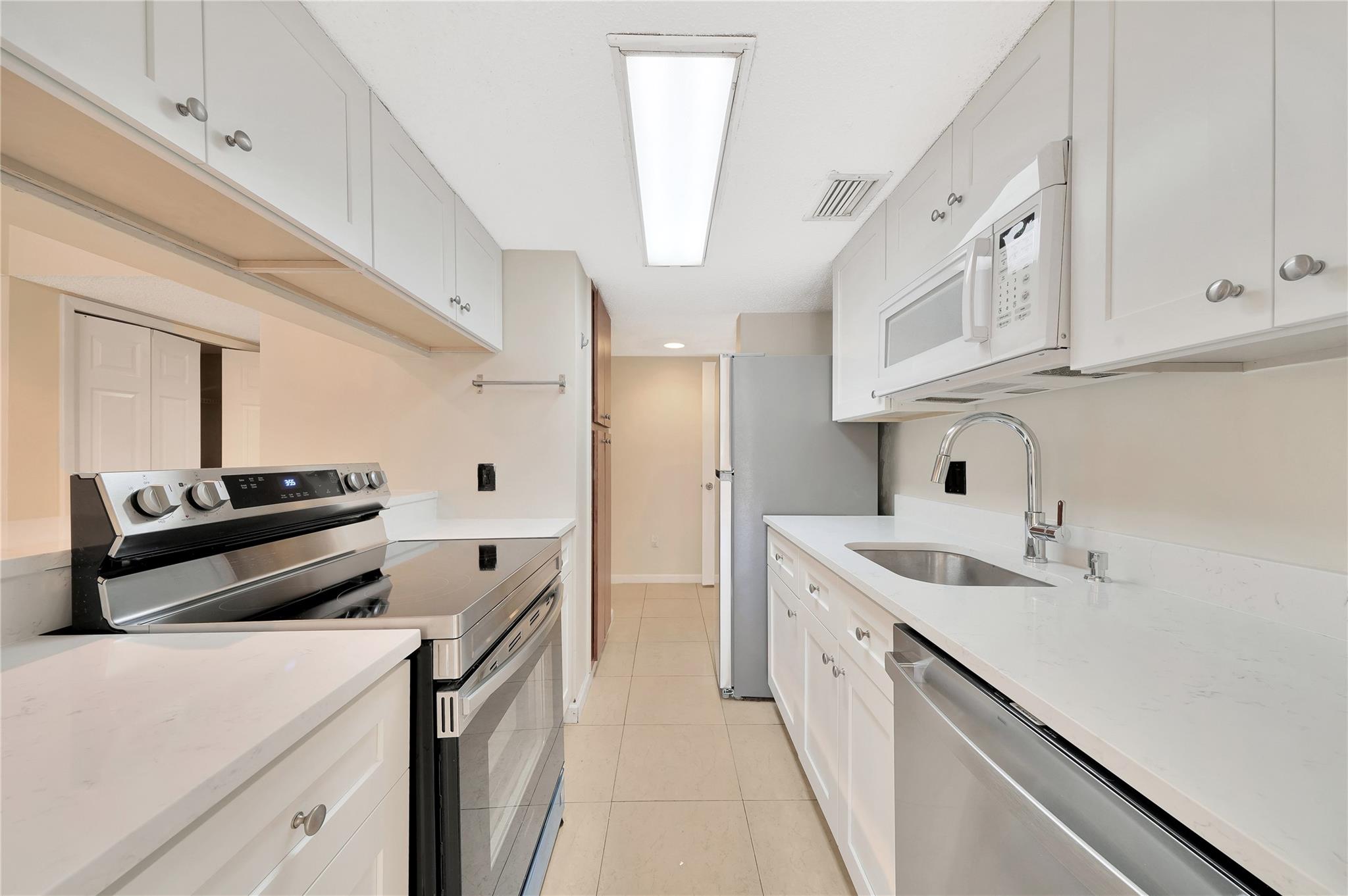 Your future home awaits with this spacious 2/2 in the well-maintained Palm Aire Gardens! Located on the second floor, this corner unit features a split floor plan, tile floors, updated vanities, and a guest bathtub/shower, along with large walk-in closets. It includes a washer/dryer in the unit, and a storage closet on the balcony. The beautiful kitchen comes with all new appliances. Freshly painted and move-in ready! It's part of a gated community with roving security guard, two pools, two tennis courts, and a gym, centrally located close to I-95, Turnpike, shopping, and dining. Water/sewer/trash is included. The community is pet-friendly with restrictions. Access to 2 community pools and gym is included. Don't wait - this will go fast!