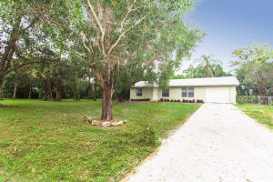 Beautiful 3 bedroom, 2 bath home on 1.01 acres of land in the highly desirable community of Palm Beach Ranchettes. New modern style kitchen featuring mocha custom cabinetry, granite countertops and stainless steel appliances. Bathrooms have been updated with new vanities, fixtures and decorative tile inlay in showers. New tile flooring throughout. Spacious fenced backyard with large open patio. Great for entertaining. Room for a pool, RV or boat!