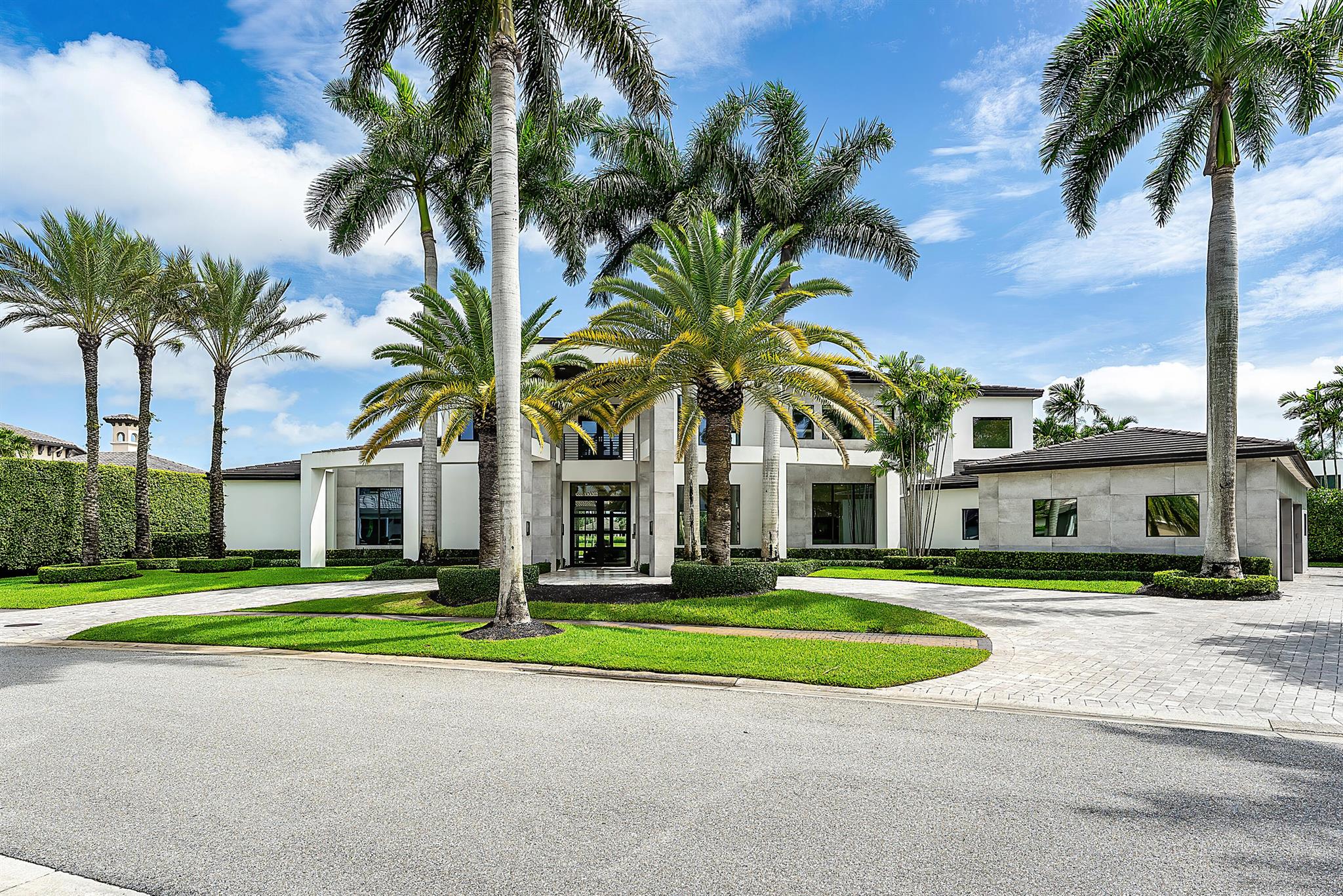 Style, space, and function come together to create perfection in this unparalleled custom-built estate located on a private, quiet, oversized one-half acre lot in St Andrew's Country Club. Every detail was thoughtfully considered, and no expense was spared in designing this over 9,000 living sq ft, 6 bedroom, 8.1 bath modern home which has beautiful fairway and lake views. A circular driveway leads to the front entrance, which has dramatic and unique architectural detail. Inside, the living and dining rooms are the initial focal point with sliding glass doors opening to reveal a spacious outdoor living and dining area. The true chef's kitchen with a double island features a Wolf 6-burner stove with griddle and double oven, two Miele dishwashers, Miele steam oven, Miele microwave,
