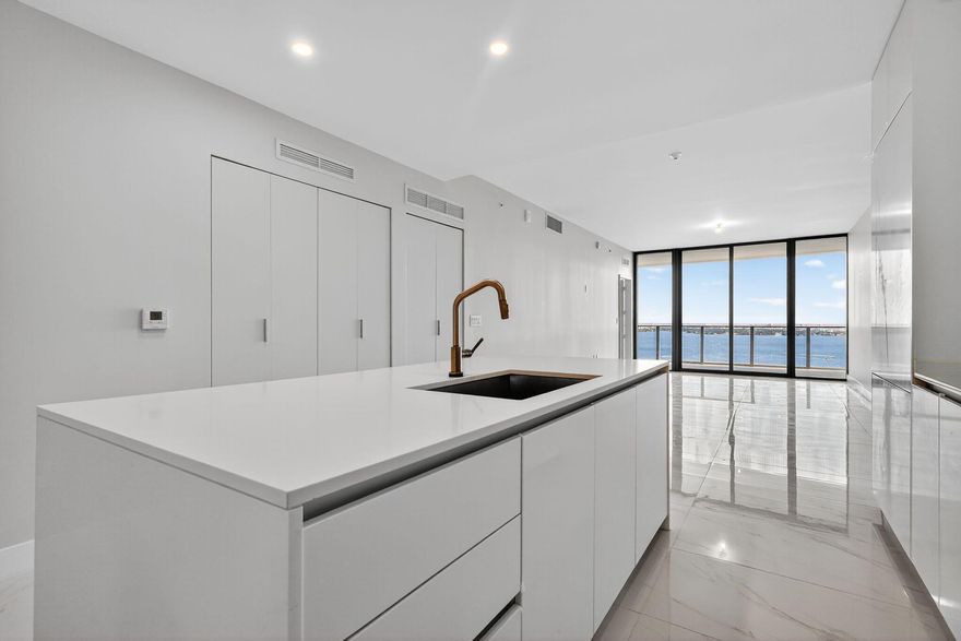 Skip the standard listings! This Aria Reserve South Tower residence redefines bayfront living.  Stunning water and city views, with custom closets, designer drapes, premium shades, and new lighting already in place. Offered furnished at $10,500 (ready in 2 weeks) or unfurnished at $9,500, both move-in ready. Features 2 bedrooms plus office, 3 baths, 1 garage space and 1 valet. Sleek open kitchen with island seating and built-in appliances. Enjoy resort amenities including pool, spa, gym, sports courts, kids areas, and a private wine cellar in Miami's most connected neighborhood, steps from Whole Foods, Trader Joe's, Midtown, Wynwood, and the beach.