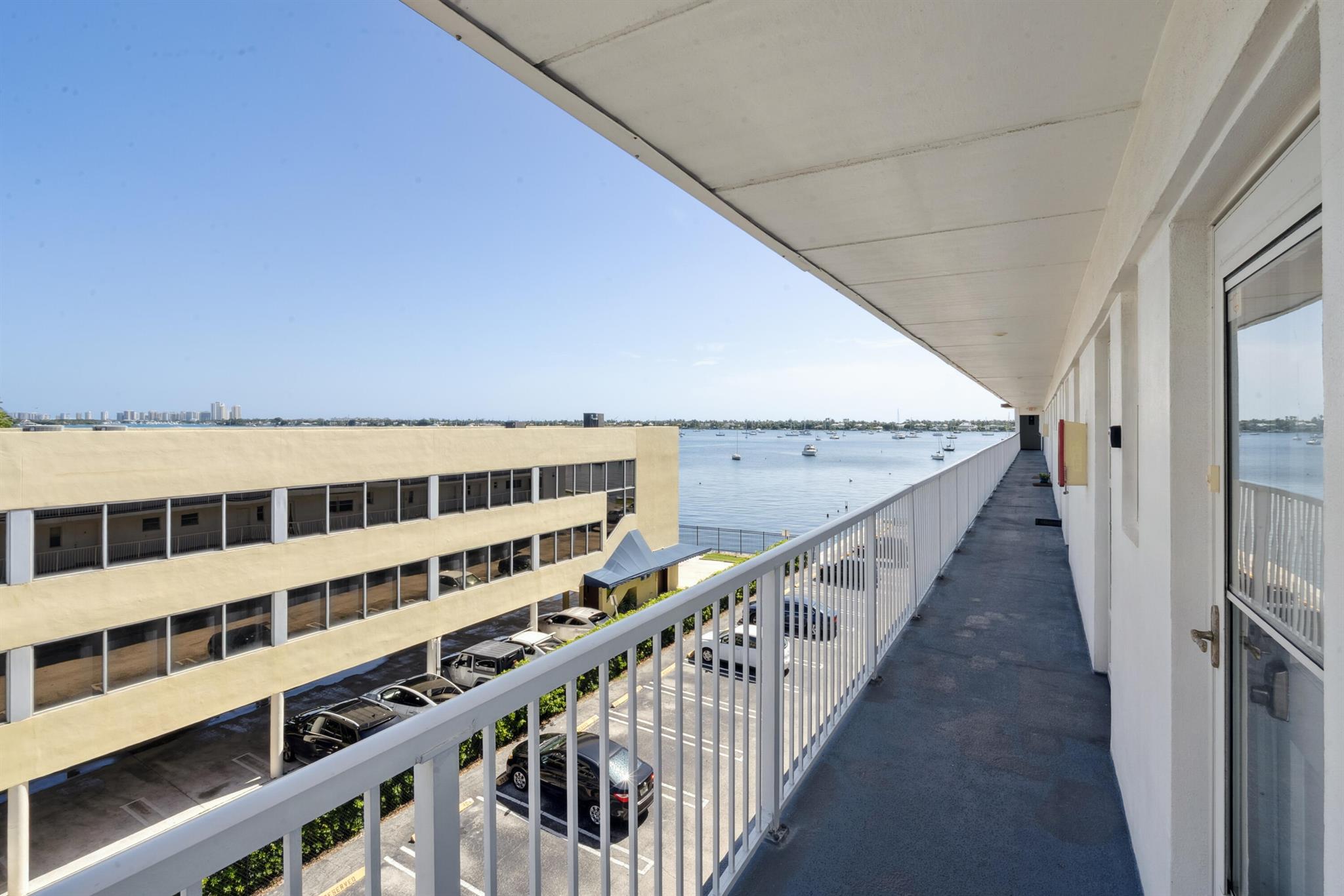 Rent right away in this updated 1BD/1BA penthouse condo with Peanut Island views from the front door and Intracoastal scenery from the enclosed porch and overlooks the pool! Features include impact windows & doors, dual entrances, Jack & Jill bath with tub/showercombo, and a parking space right in front of the unit. Just 2 doors from laundry and 5-7 minutes to PBI, Downtown West Palm, beaches & shopping. Upgrades include rechargeable remote blackout shades, fresh Ben Moore paint, new comfort-height toilet & shower heads, new glass entry door with electronic lock, and a brand-new A/C unit installed less than a week ago. Low HOA fees and professional finishes throughout make this move-in ready home the perfect coastal retreat! Don't miss the opportunity to love where you live, coastal style
