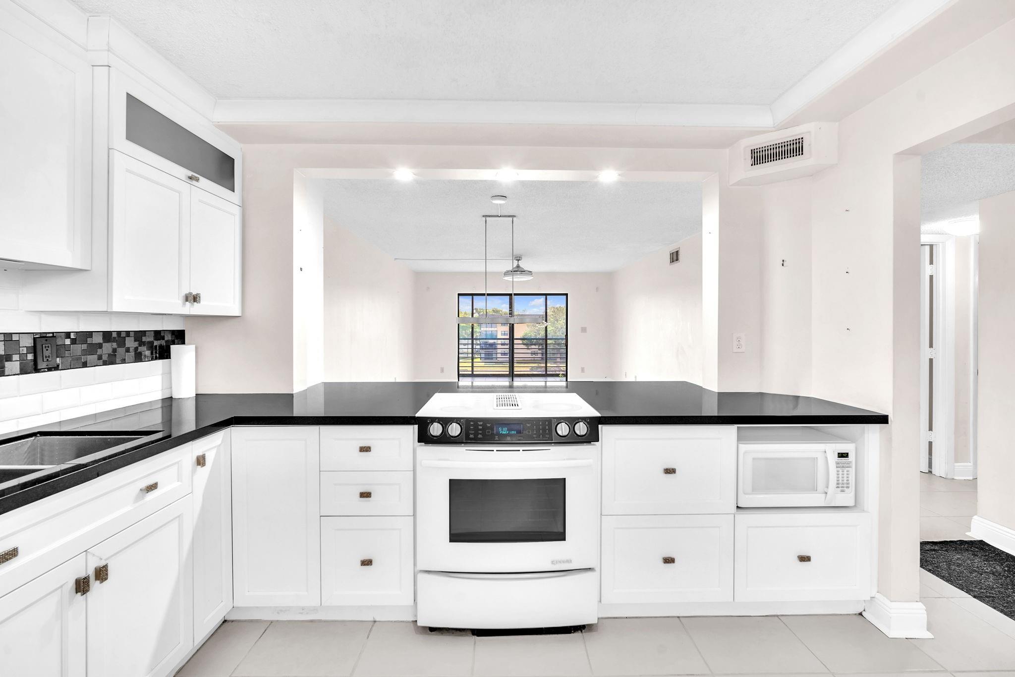 SELLERS MUST SELL, BRING ALL OFFERS!! Enjoy peace of mind with a NEW ROOF (2023), NEW A/C (2024), NEW ELEVATOR (2024), AND A NEW WASHER AND DRYER (2025). This beautiful 2/2 condo offers plenty of storage and thoughtful upgrades throughout. The kitchen and laundry room feature built-in cabinetry for added convenience. The primary bedroom boasts a new shower stall, custom remote-controlled zebra blinds, and a large walk-in closet. The spacious second bedroom also includes a generous walk-in closet. Relax on the screened and enclosed patio with lake views and a portable A/C unit for year-round comfort. Additional features include bike storage and access to a variety of great amenities in this active 55+ community. HOA includes water, basic cable, internet, and security.